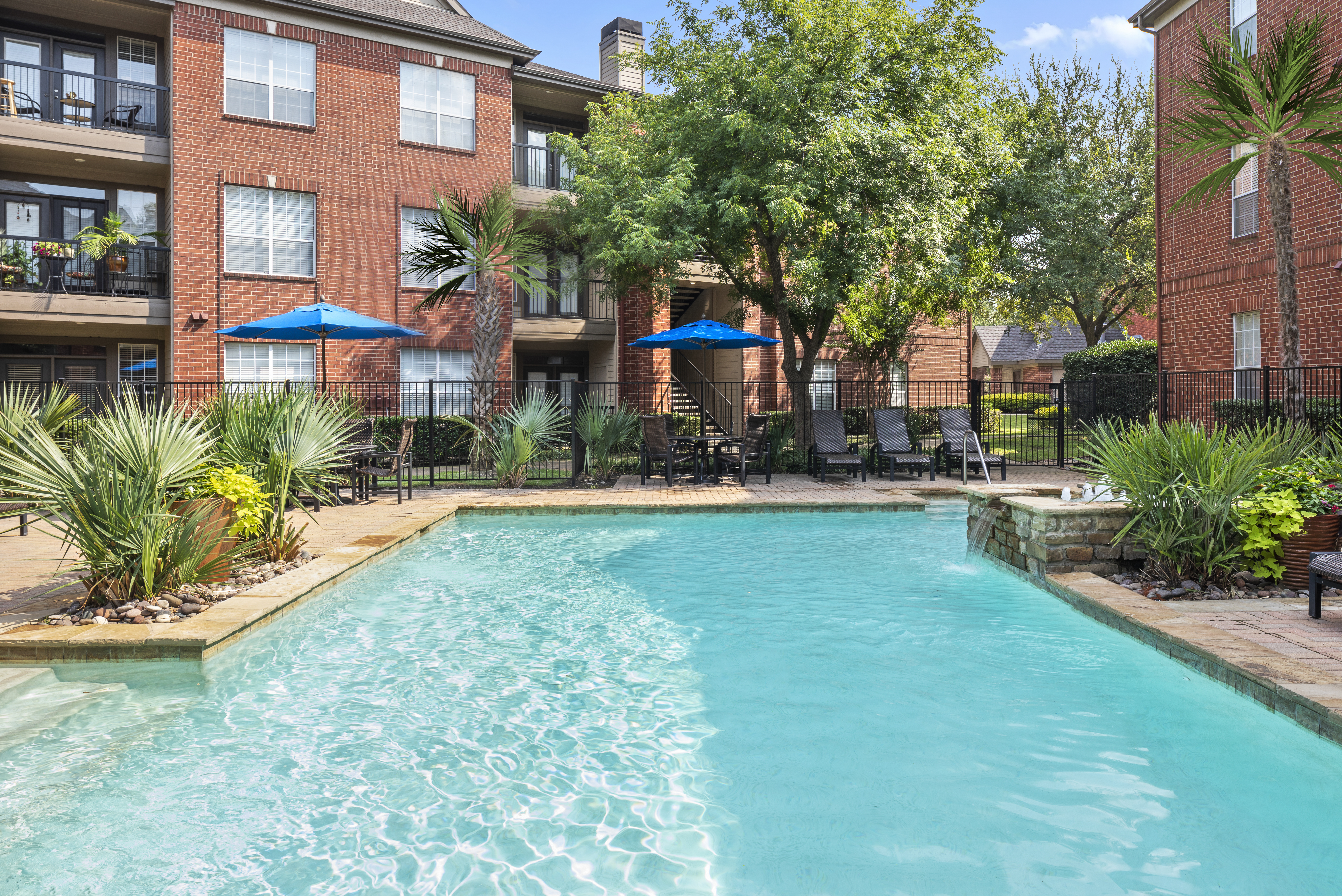 Second pool with seating and umbrellas