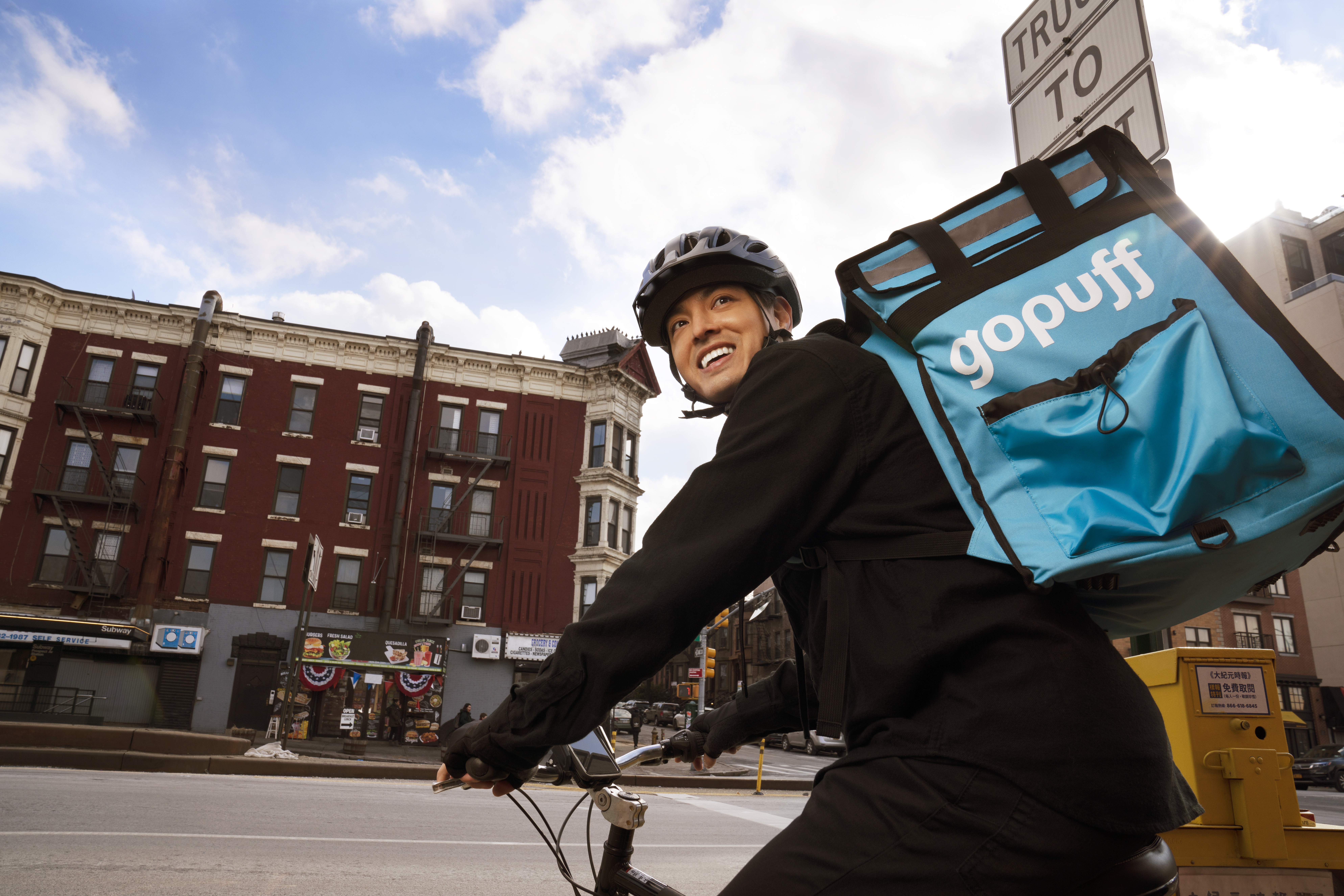 Gopuff delivery partner makes a delivery on a bicycle 