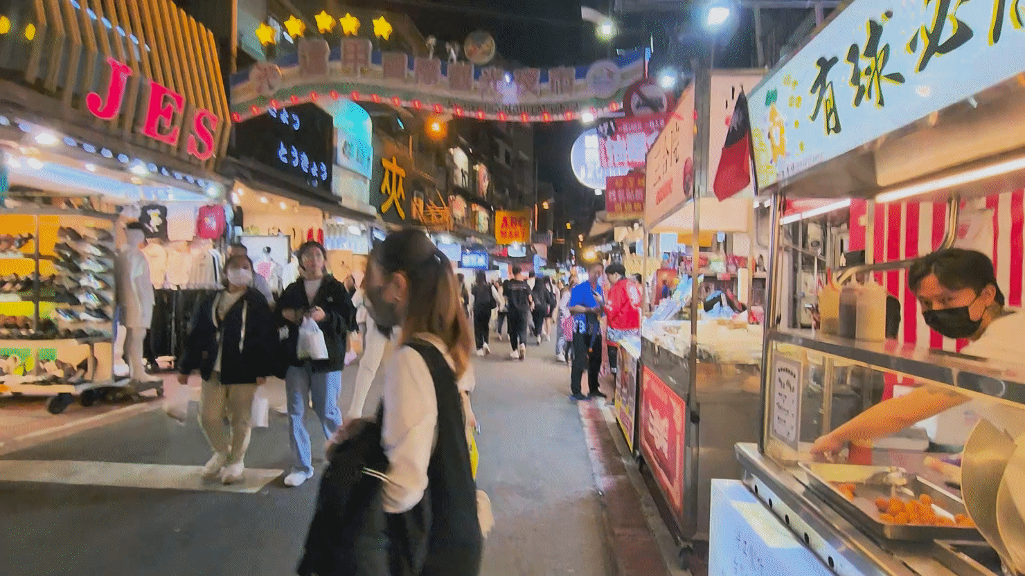 People walking through Feng Jia Night Market.