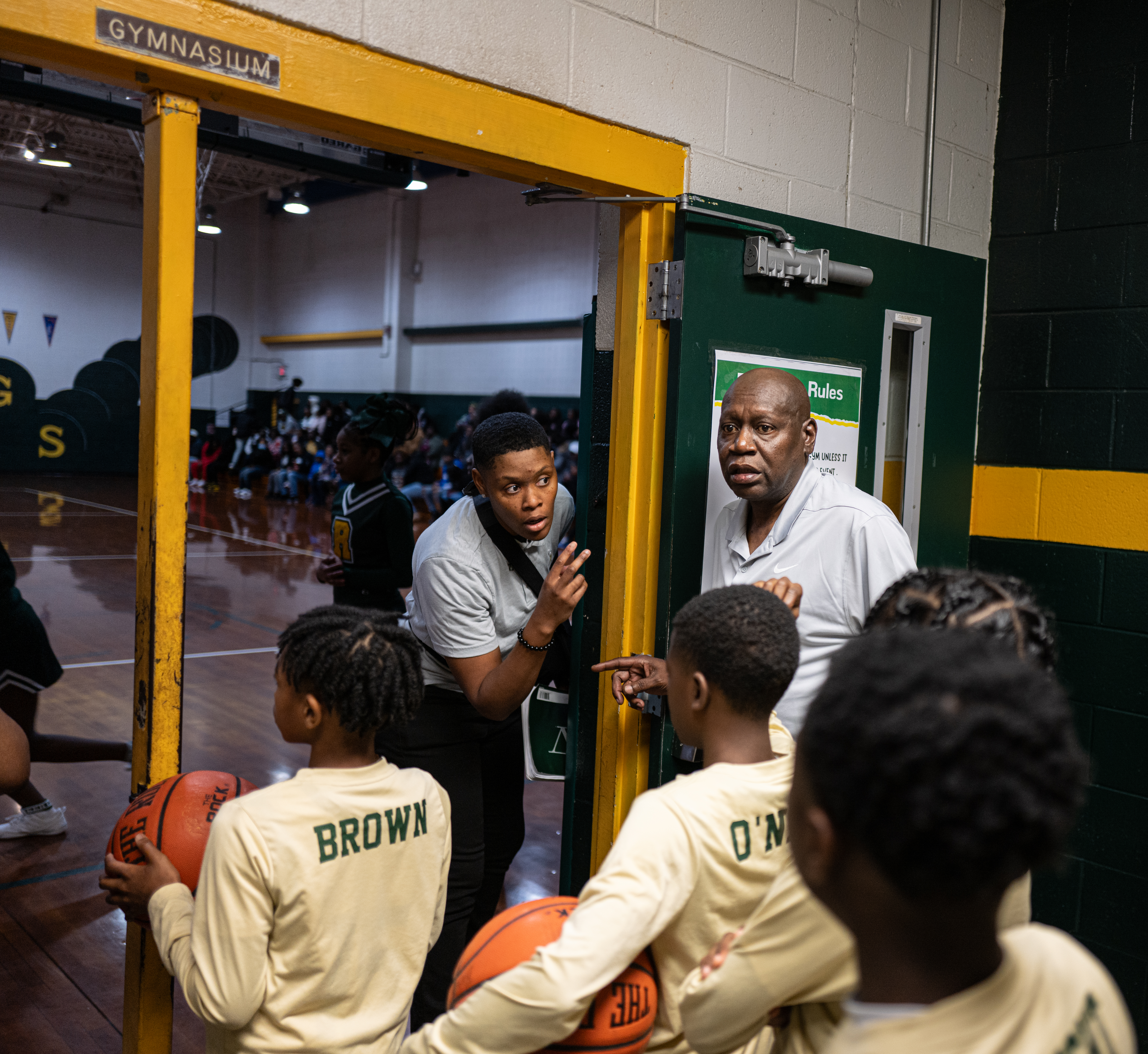 A photo of a middle school basketball team gathered in a locker room.