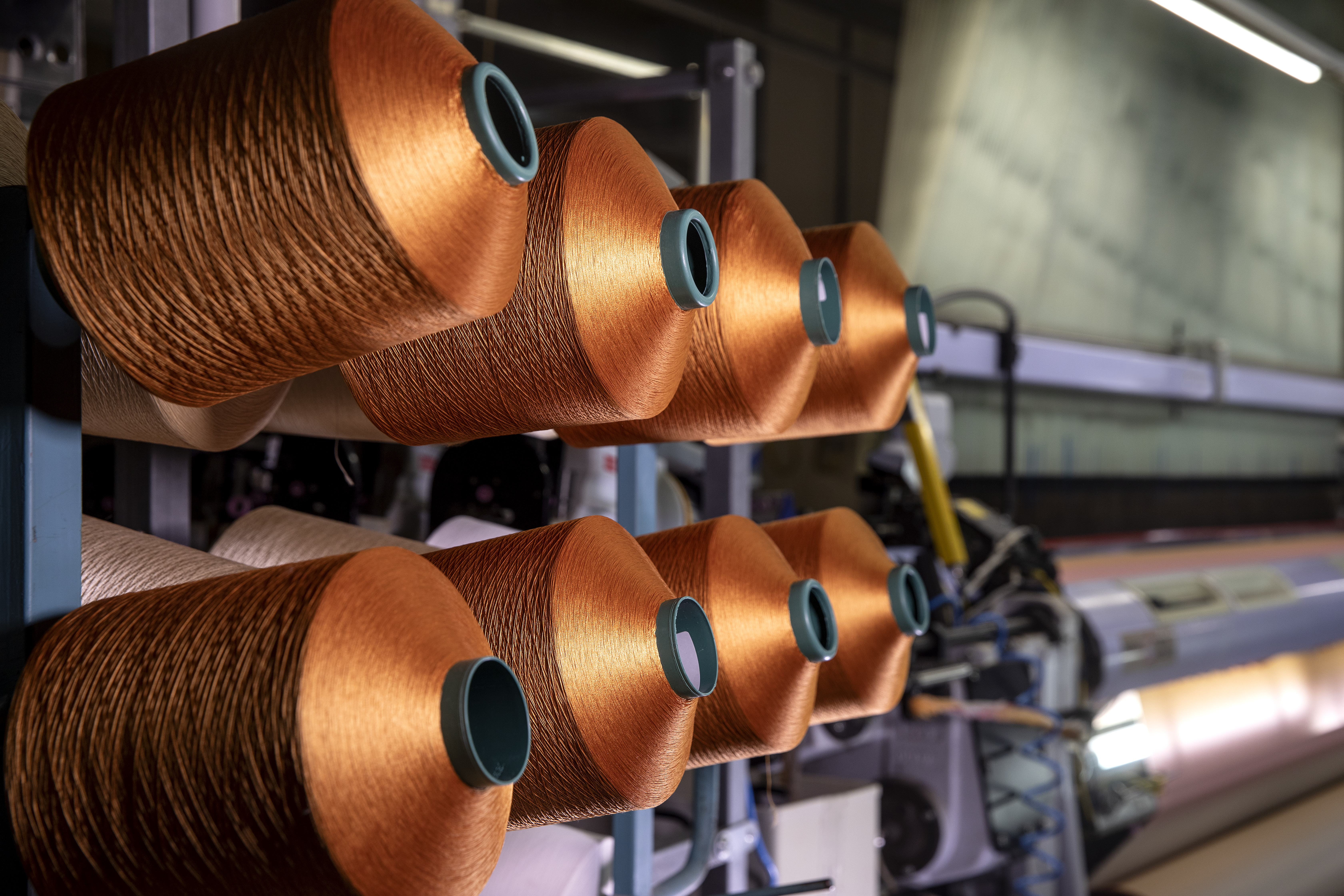 copper colored spools of thread