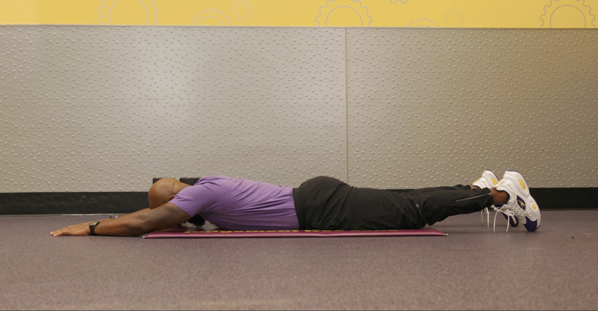Man performing lying Superman exercise in Planet Fitness club