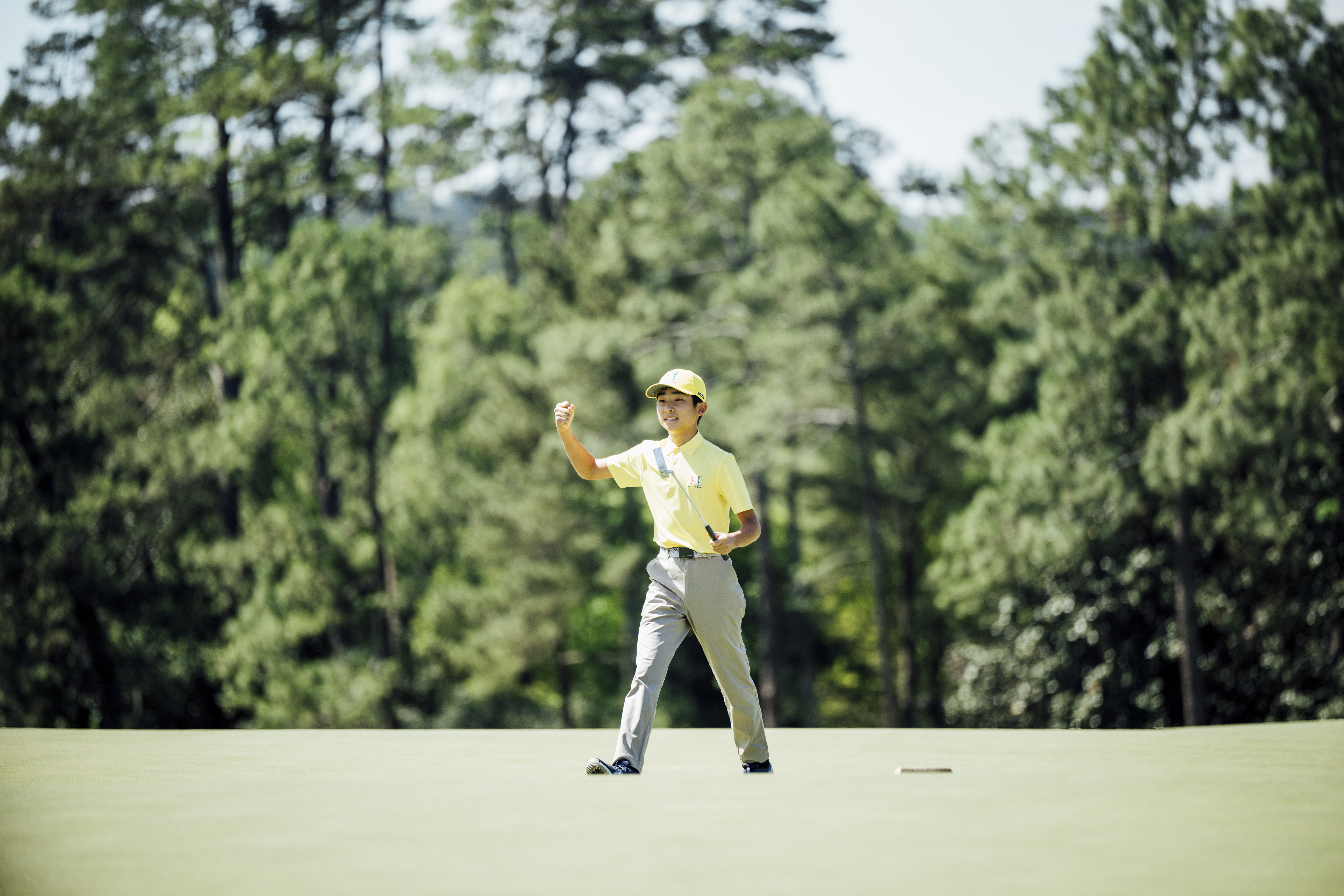 Leo Saito of the Boys 12-13 division fist pumps during the Drive, Chip & Putt National Finals at Augusta National Golf Club on Sunday, April 2, 2023. (Logan Whitton/Augusta National Golf Club)