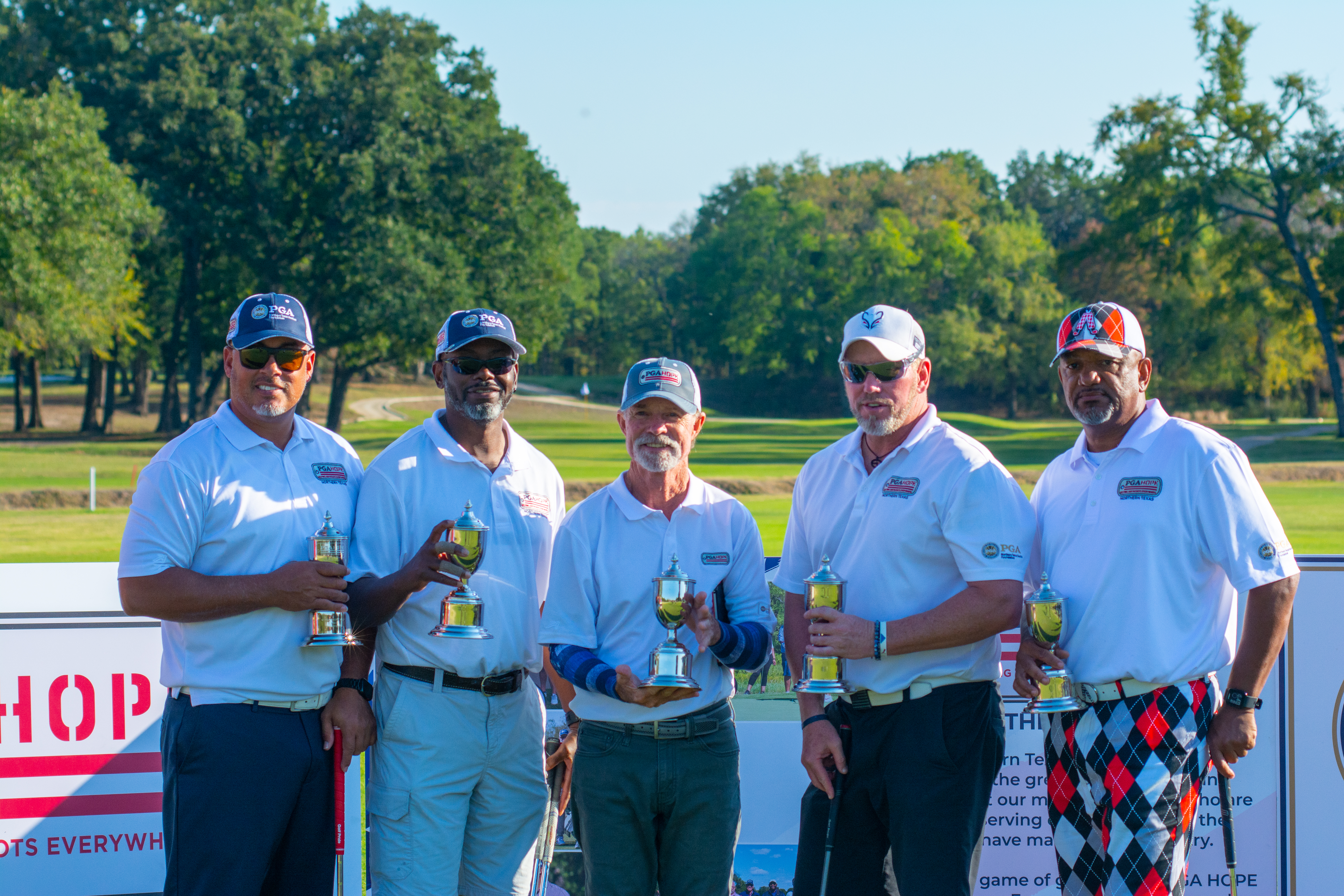 Whidbee and Williamson (second, third from left) and their winning Northern Texas PGA HOPE Cup team.