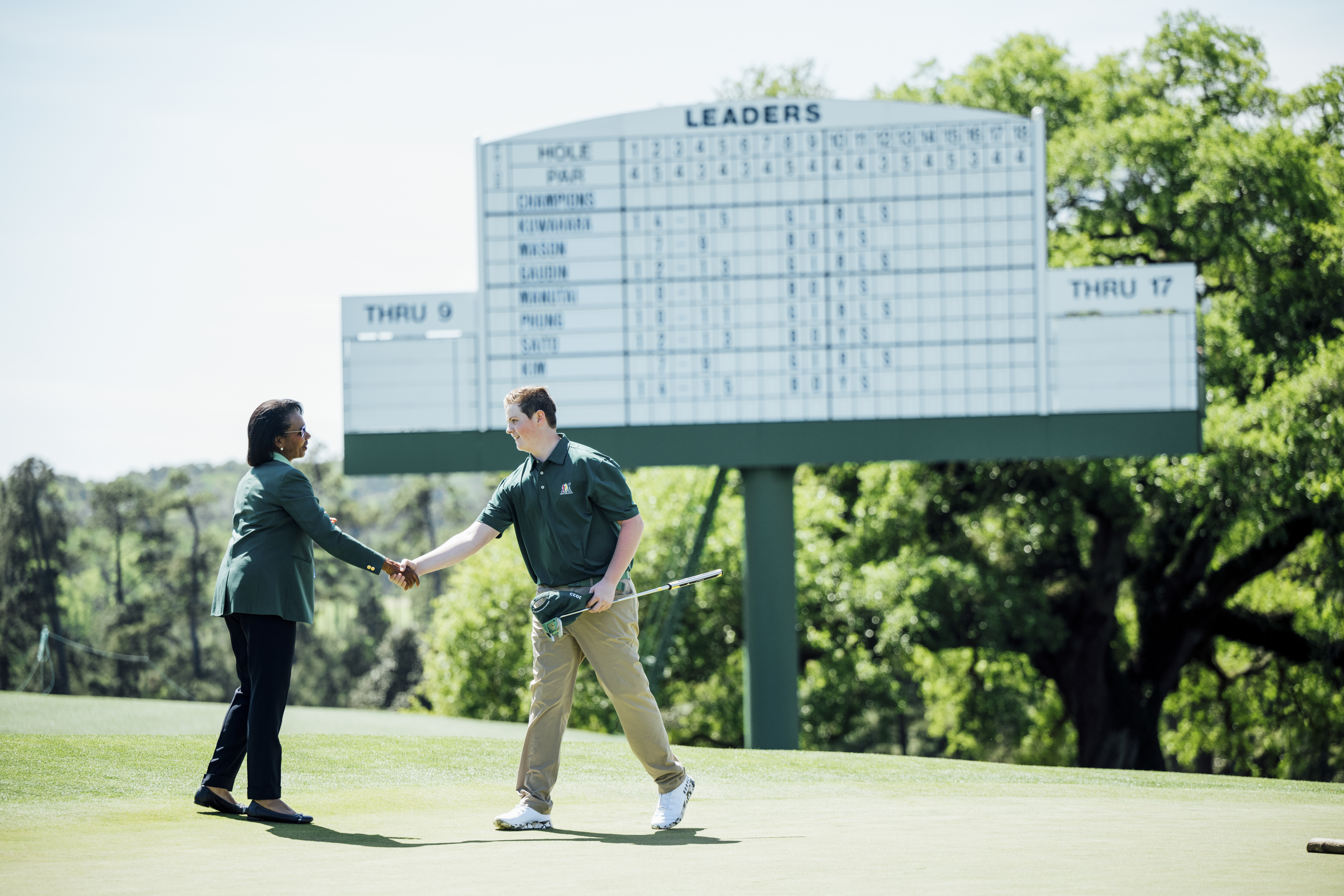 Jake Sheffield of the Boys 14-15 division is congratulated by Dr. Condoleezza Rice during the 2023 Drive, Chip and Putt National Finals at Augusta National Golf Club. (Logan Whitton/Augusta National Golf Club)
