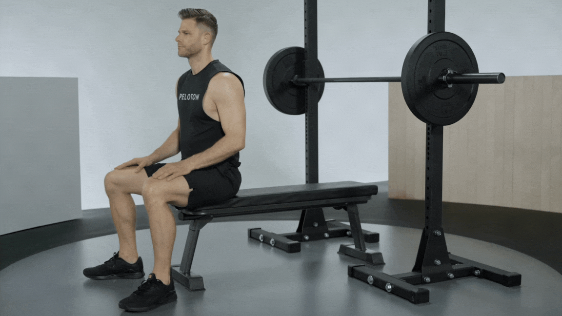 Peloton instructor Andy Speer demonstrates a barbell bench press chest exercise with proper form 