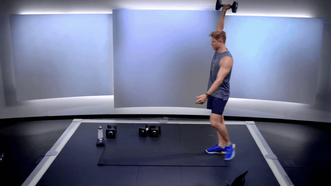 Peloton instructor Andy Speer demonstrates a unilateral overhead farmer's carry during a Peloton strength plan