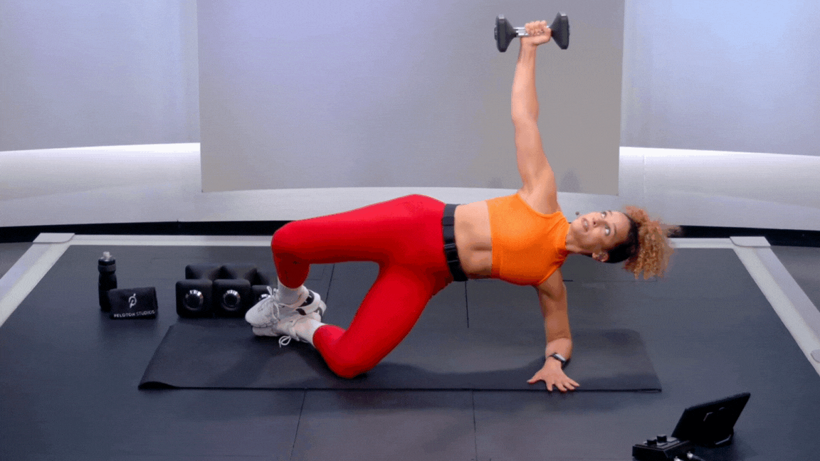 Peloton instructor Jess Sims demonstrates a bridging clamshell exercise as part of strength training for basketball players