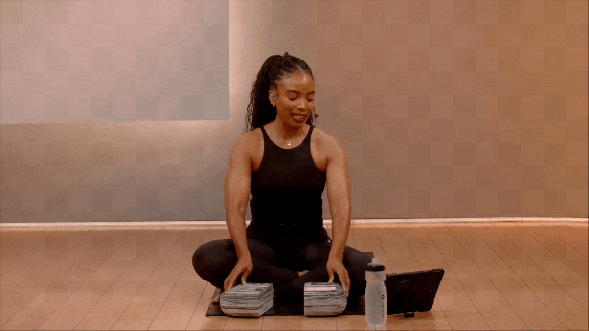 Peloton instructor Chelsea Jackson Roberts demonstrates the palm stretch