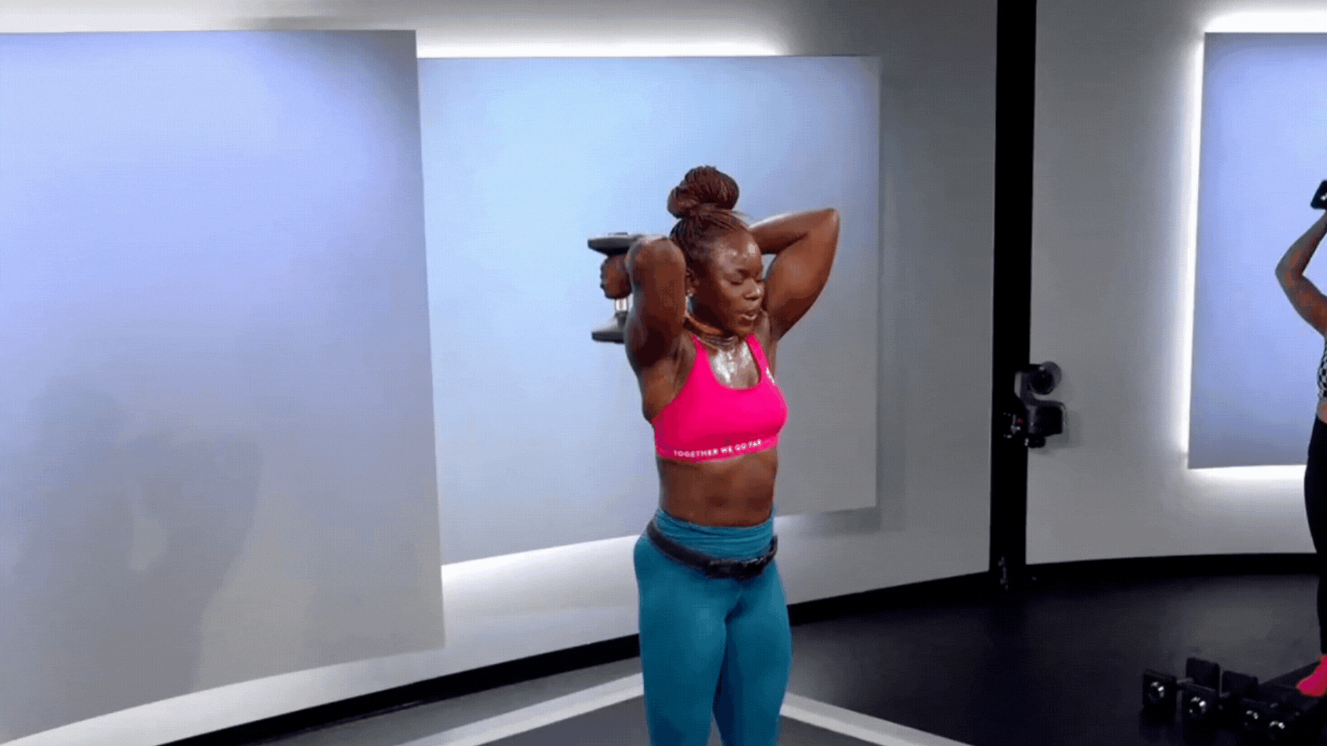 Tunde Oyeneyin doing tricep overhead extensions