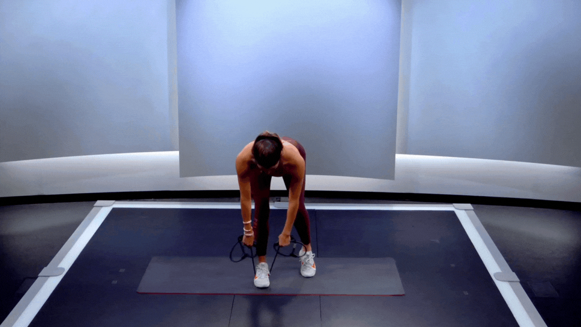 Peloton instructor Hannah Corbin demonstrates a resistance band kickstand deadlift.
