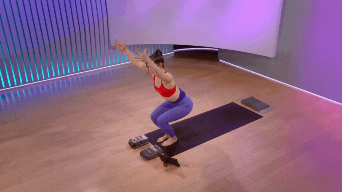 Peloton instructor Nico Sarani demonstrating Chair Pose with heel lifts as part of a pre-run yoga sequence