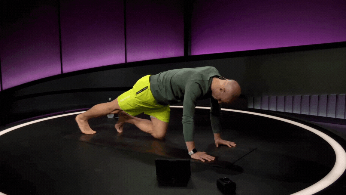 Peloton instructor Marcel Maurer demonstrates a single-leg plank calf stretch during a foot and ankle mobility class