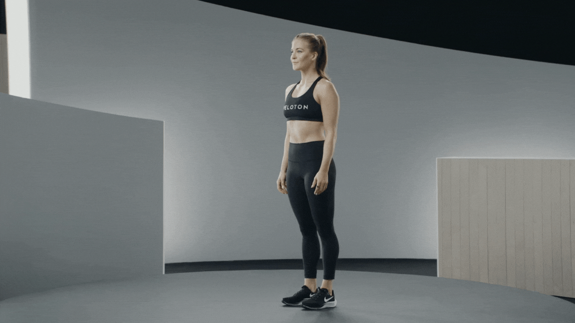 Peloton instructor Rebecca Kennedy demonstrates a bodyweight squat with proper form.