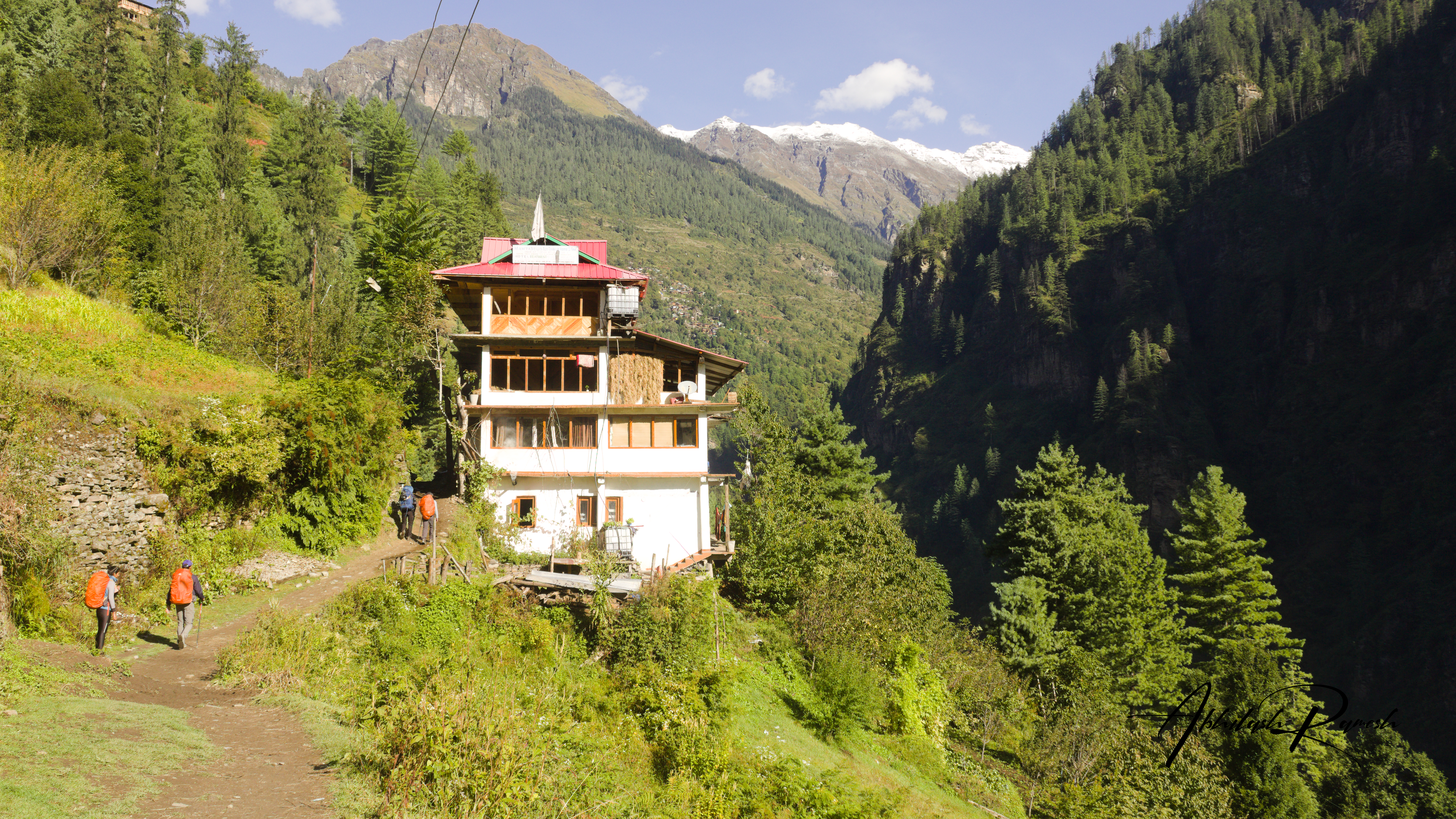 trek mates walking on the trail and houses