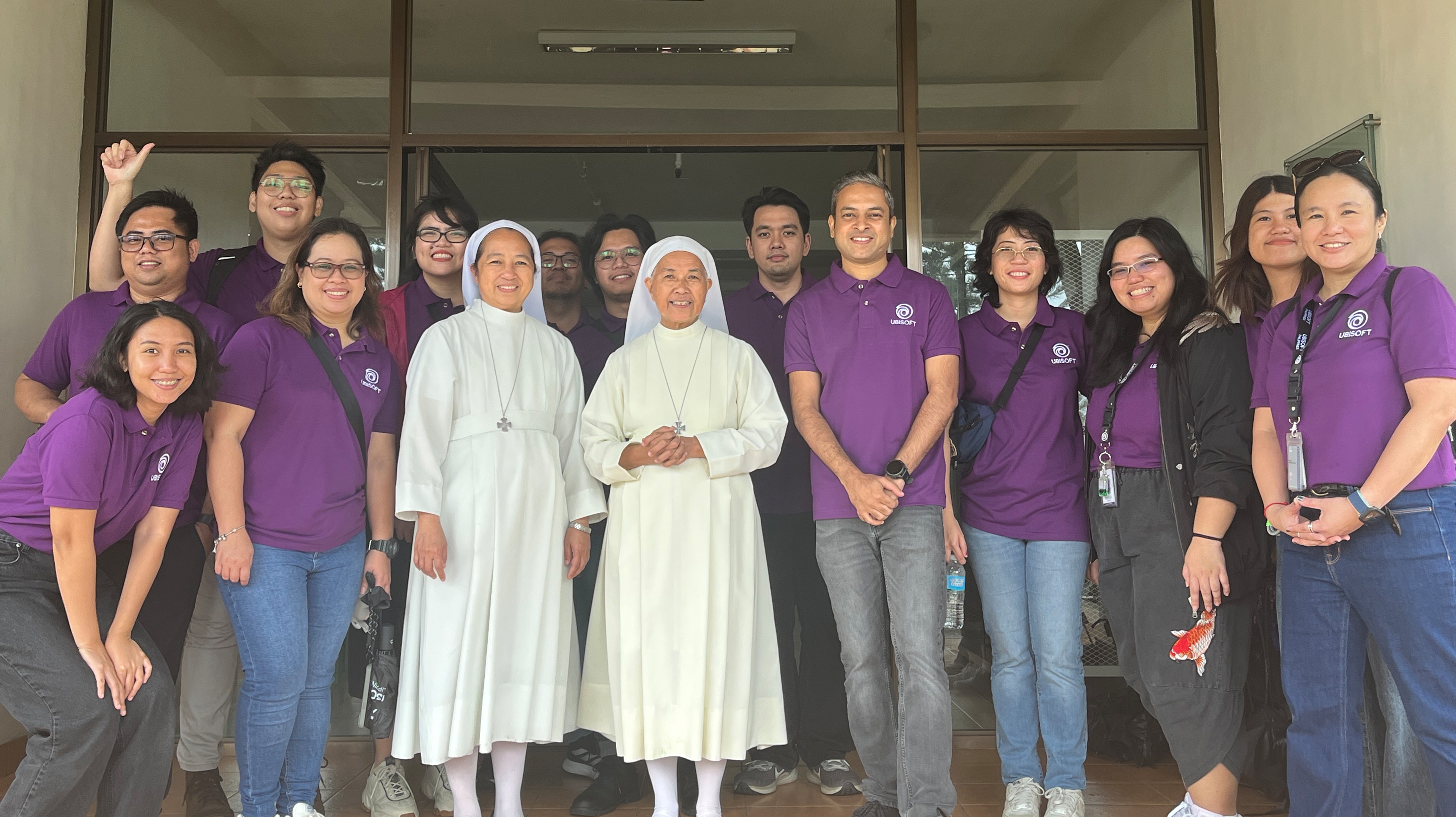 Ubisoft team members posing with a couple of sisters