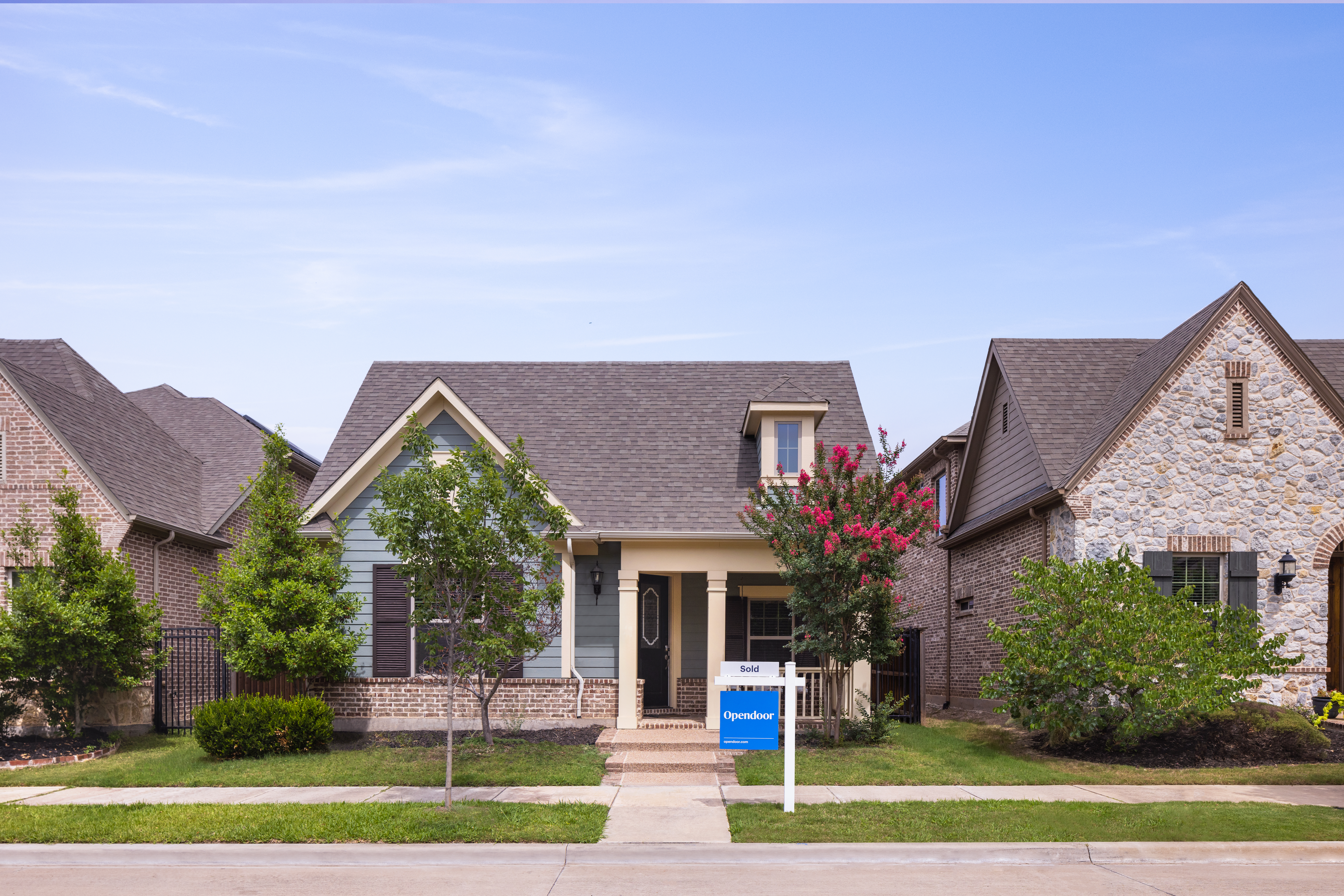 exterior home with sold sign