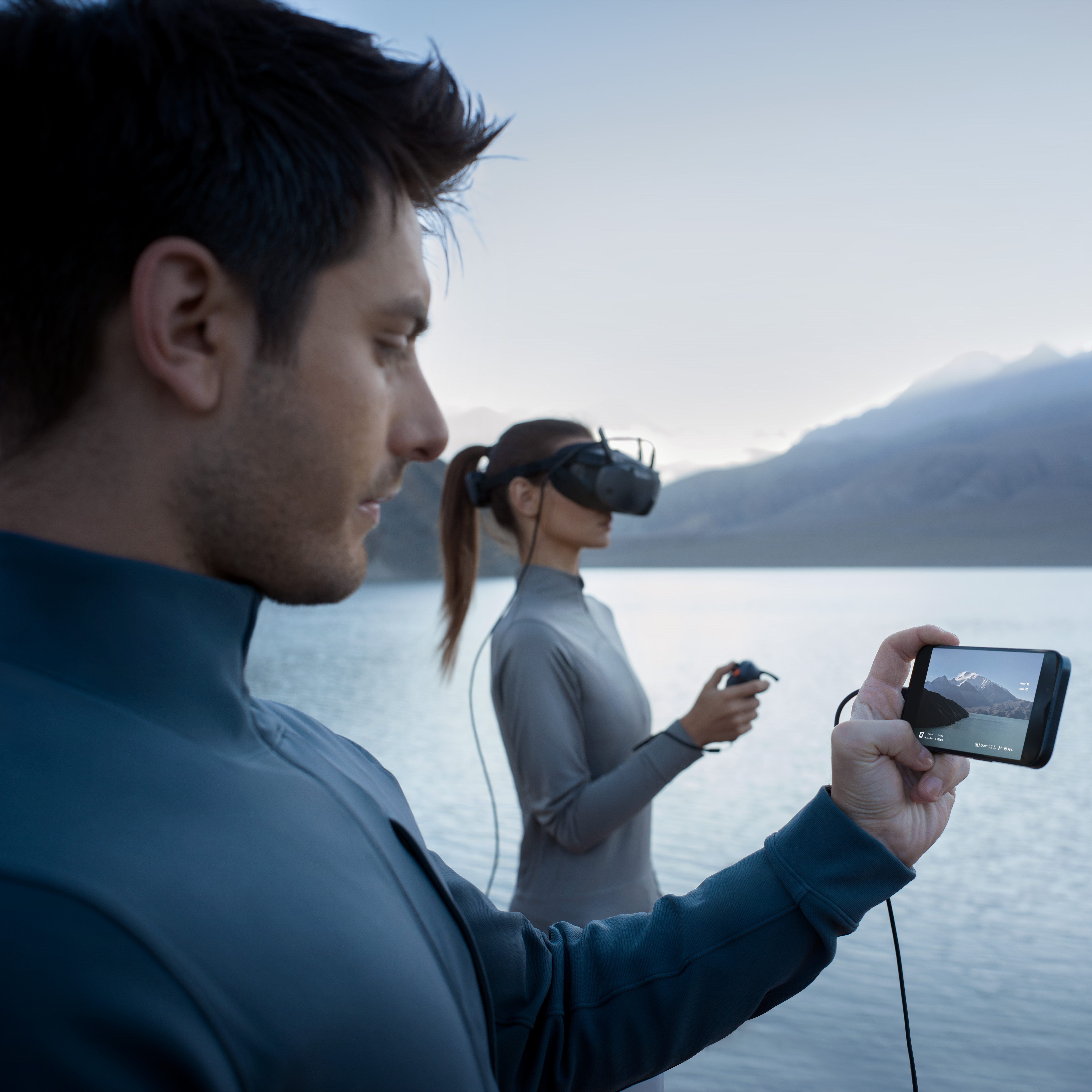 Operator wearing DJI Googles N3 and using with RC 3 and streamlining footage on phone.