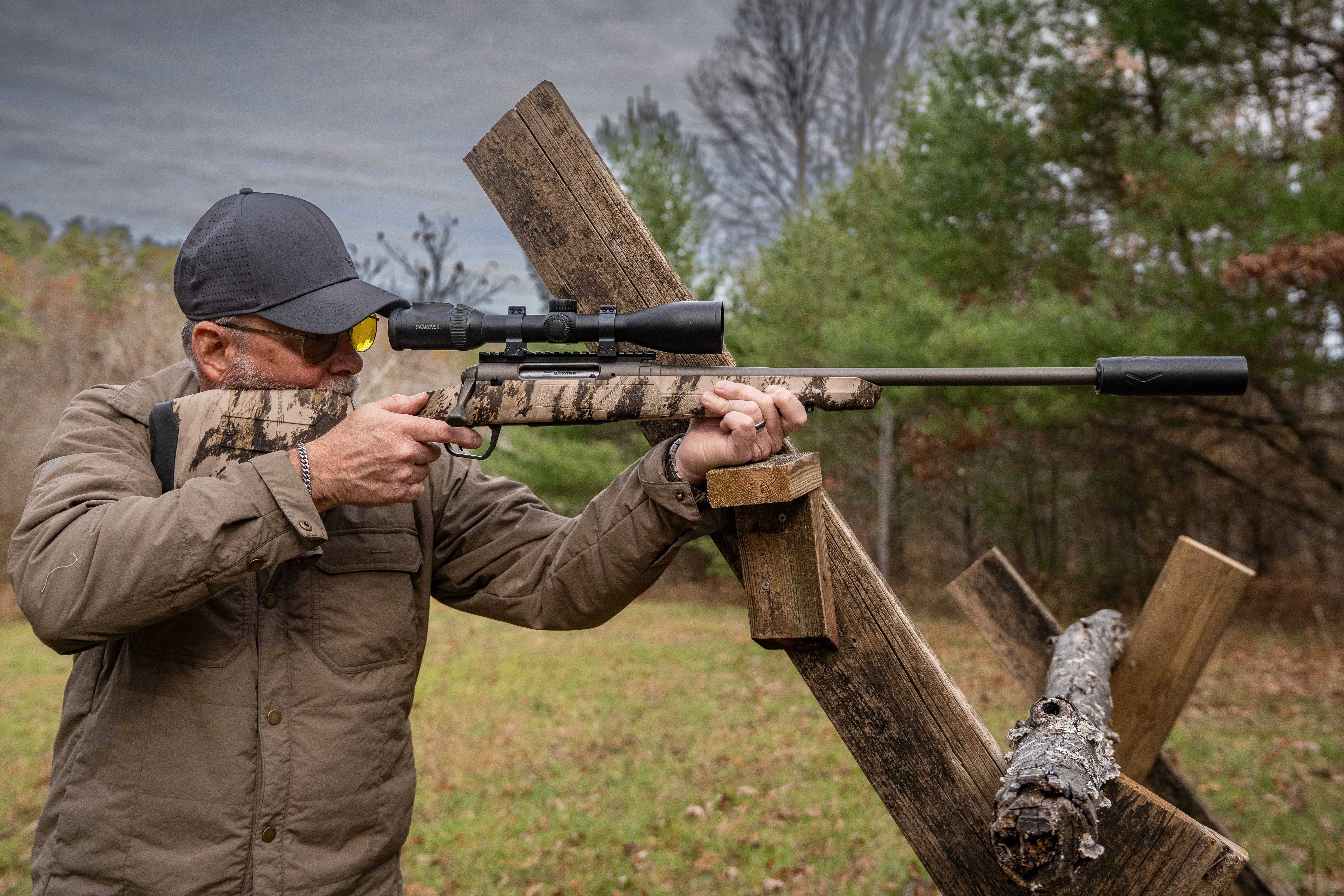 A shooter fires the Savage Axis 2 Pro from a barricade. 