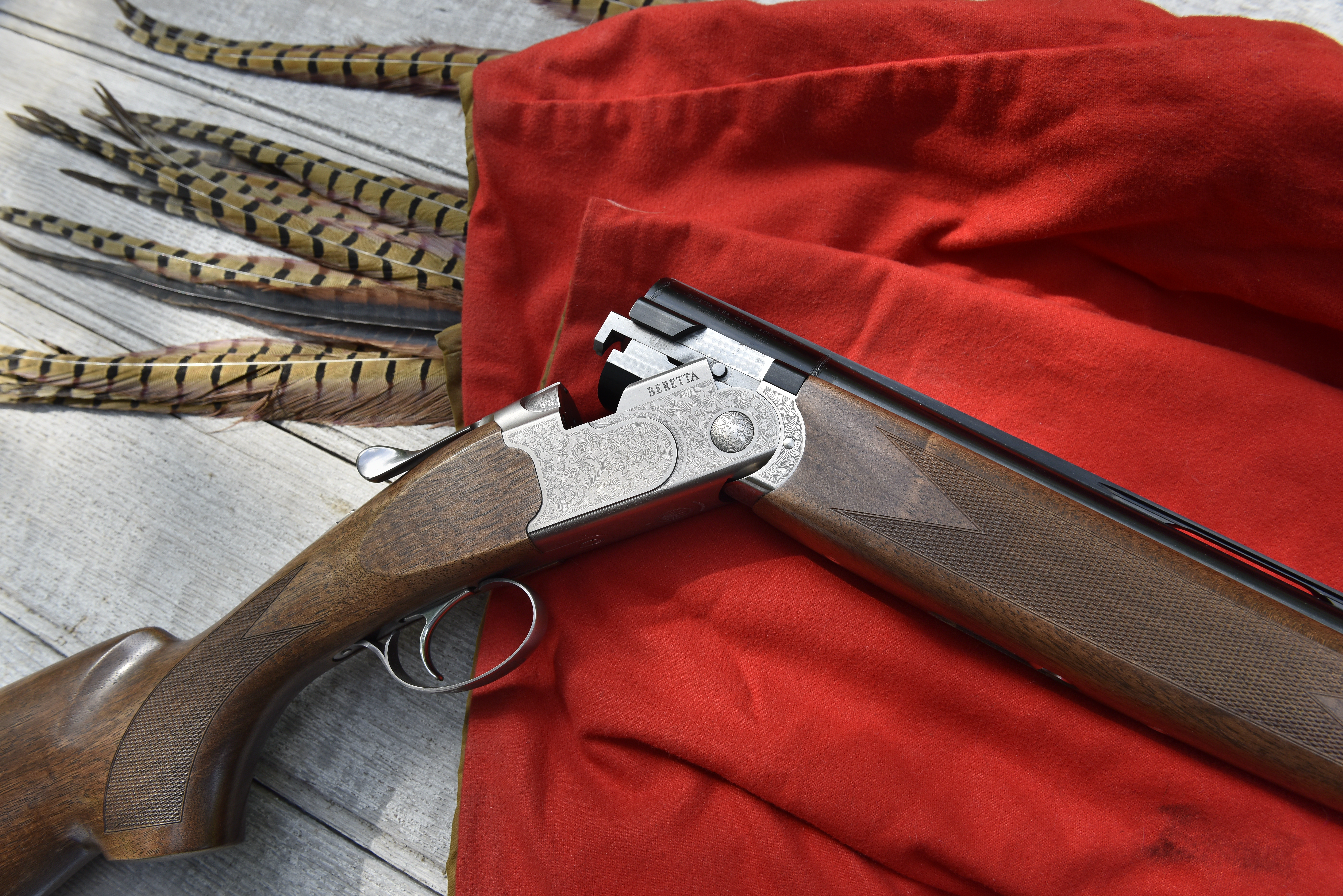 Beretta's new 686 Silver Pigeon I O/U shotgun on red blanket.