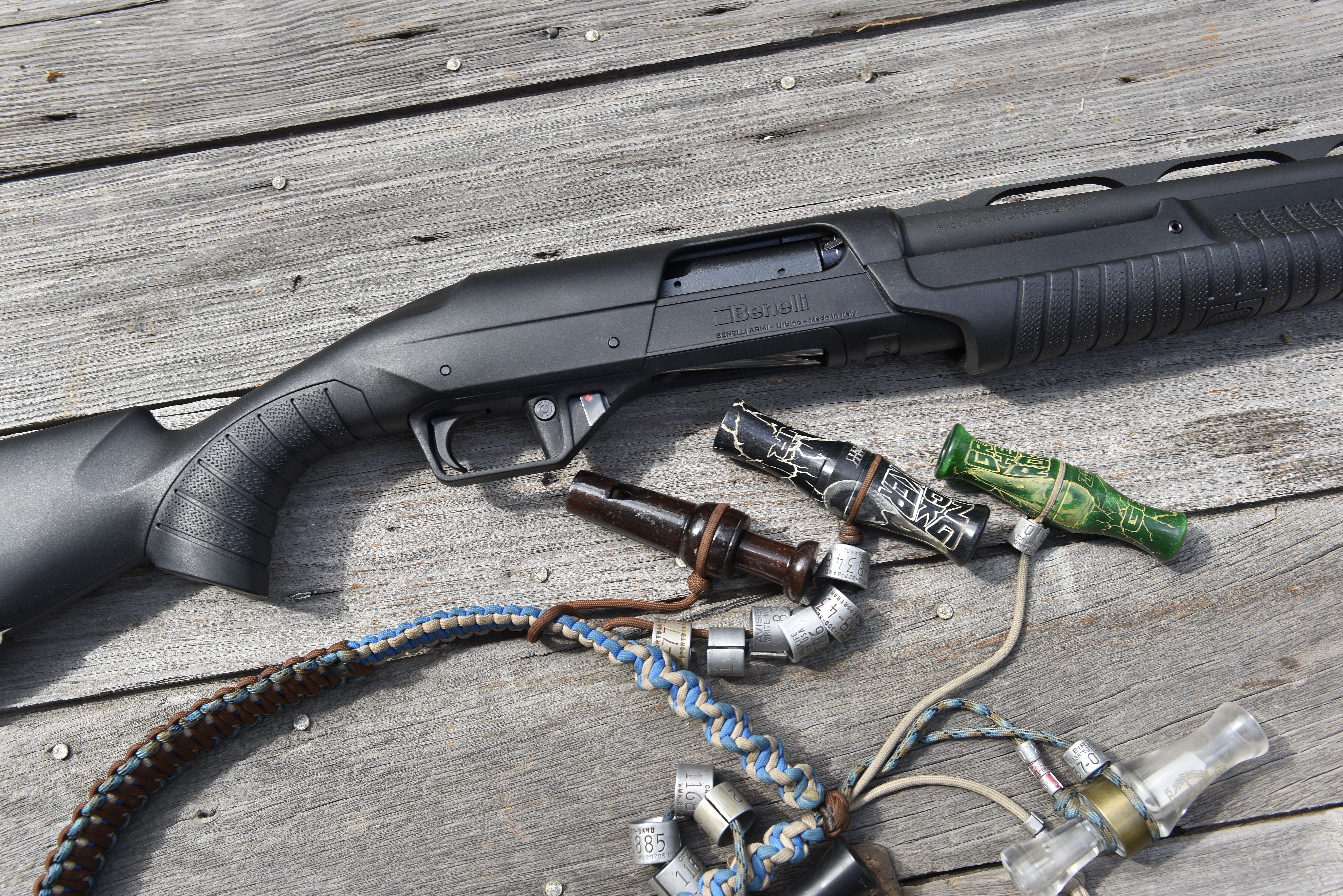 The new Benelli Nova 3 shotgun shown with a lanyard of duck calls. 