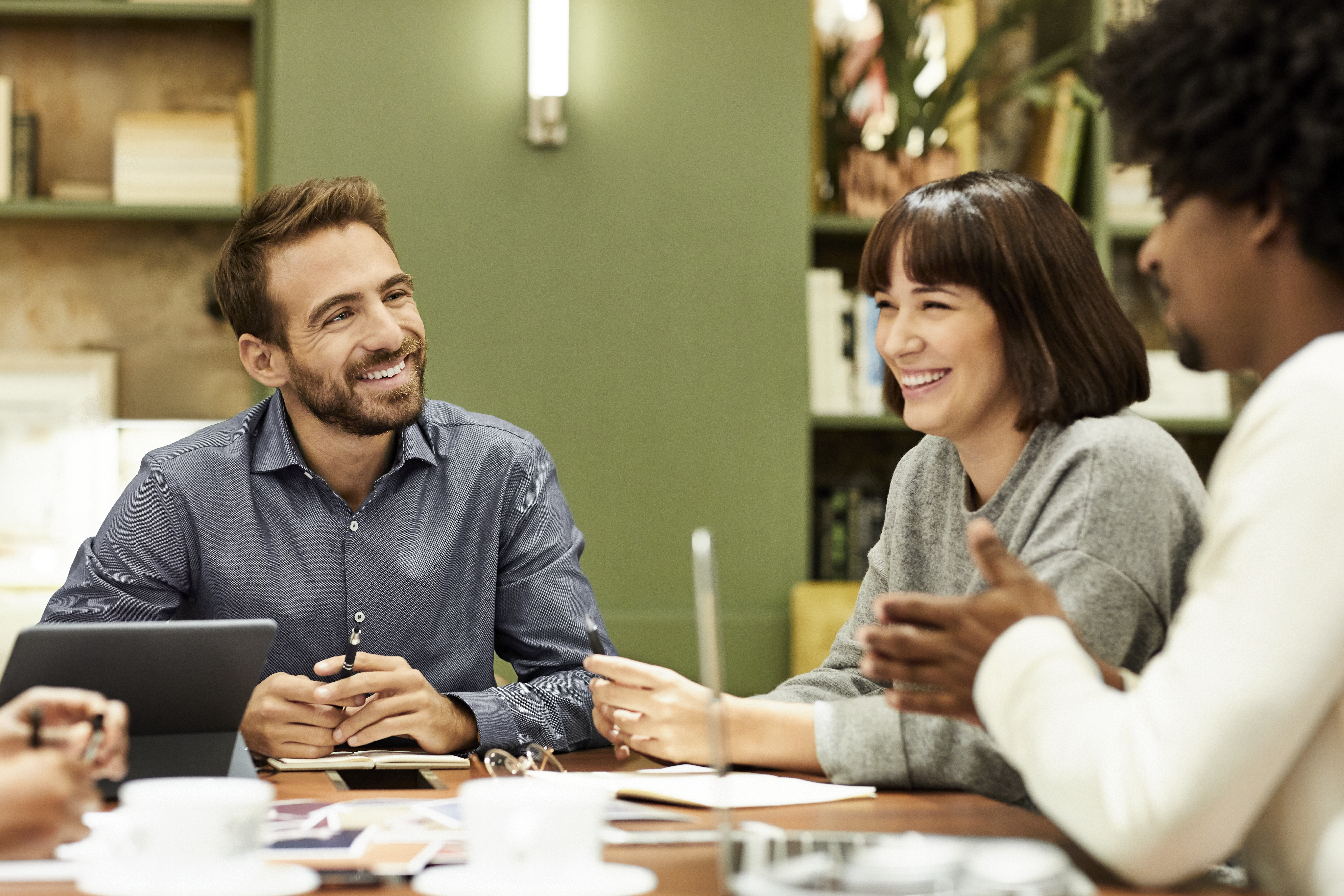 Colleagues discussing during meeting in office