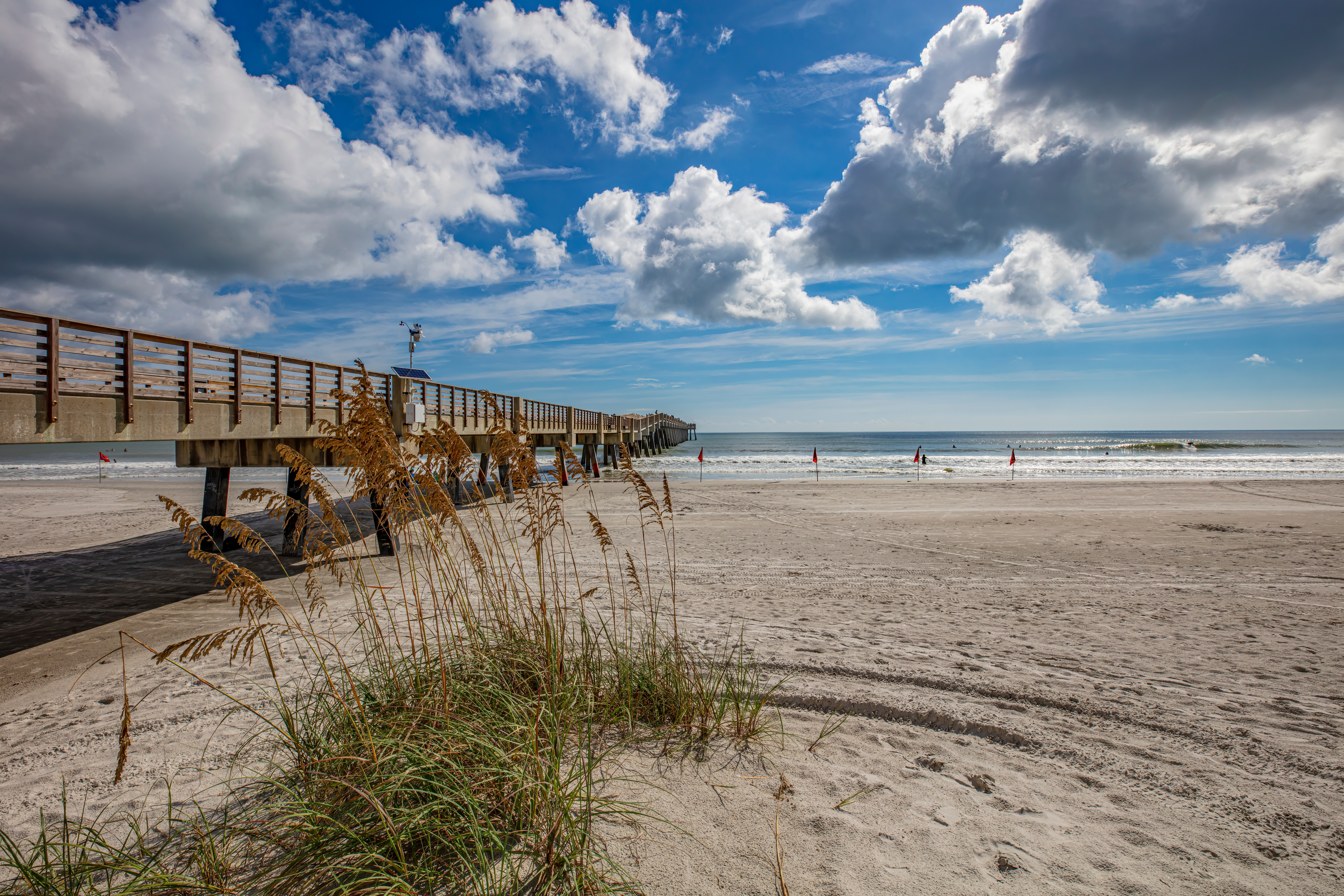 Wooden pier leading out to the beach on a sunny day