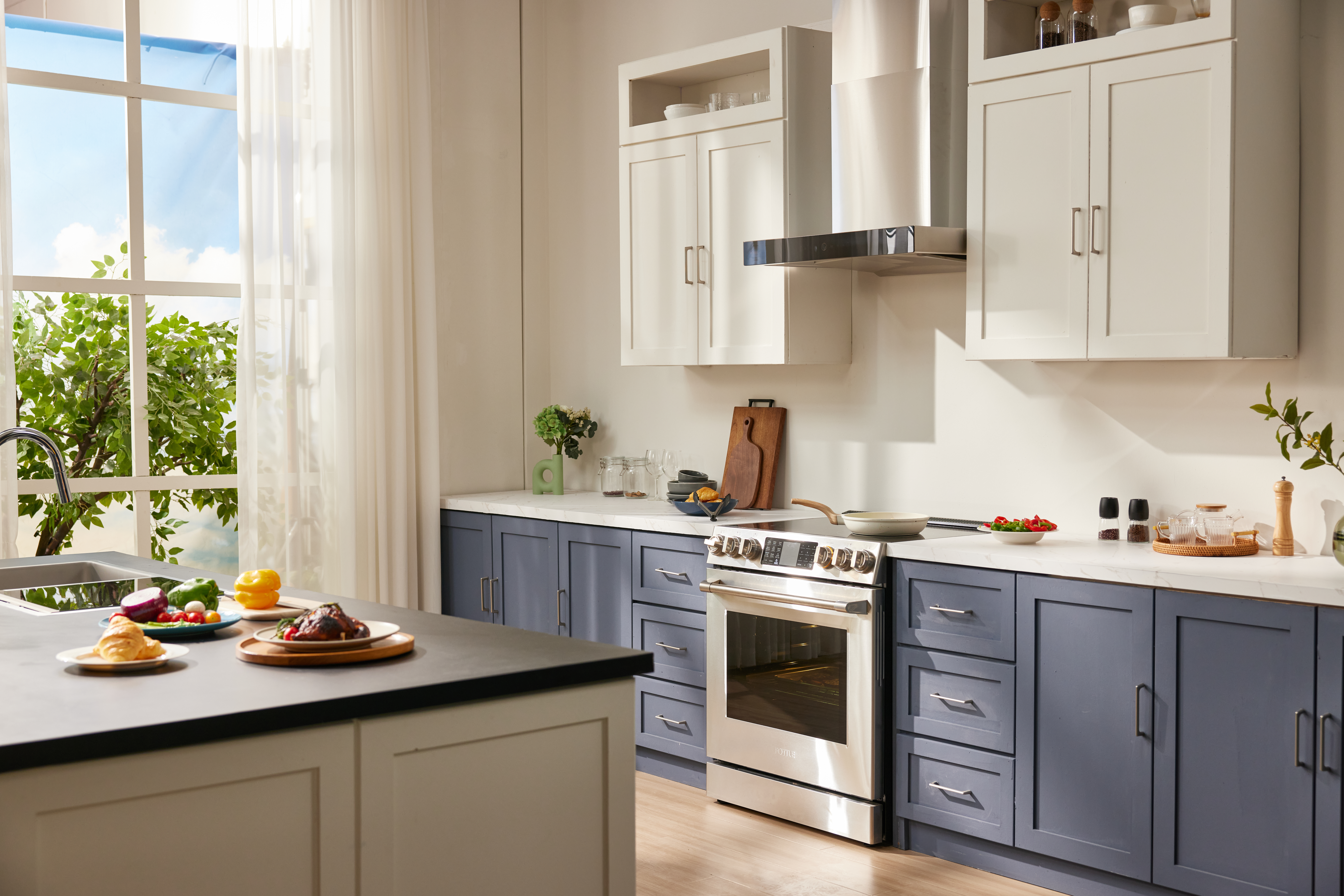 kitchen with blue lower cabinets, cream uppers and a stainless steel oven and hood range