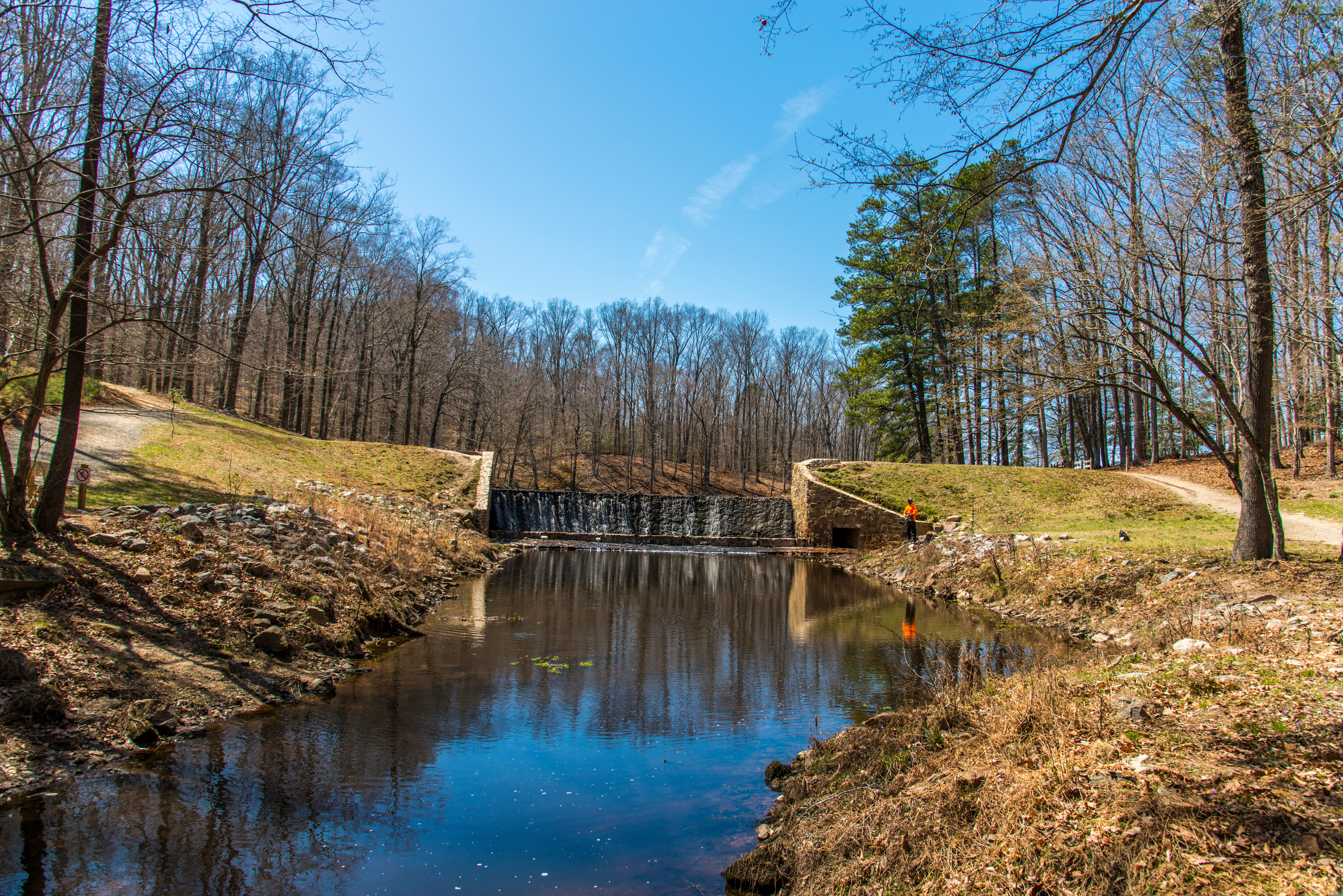 dam and waterfall in a wooded state park