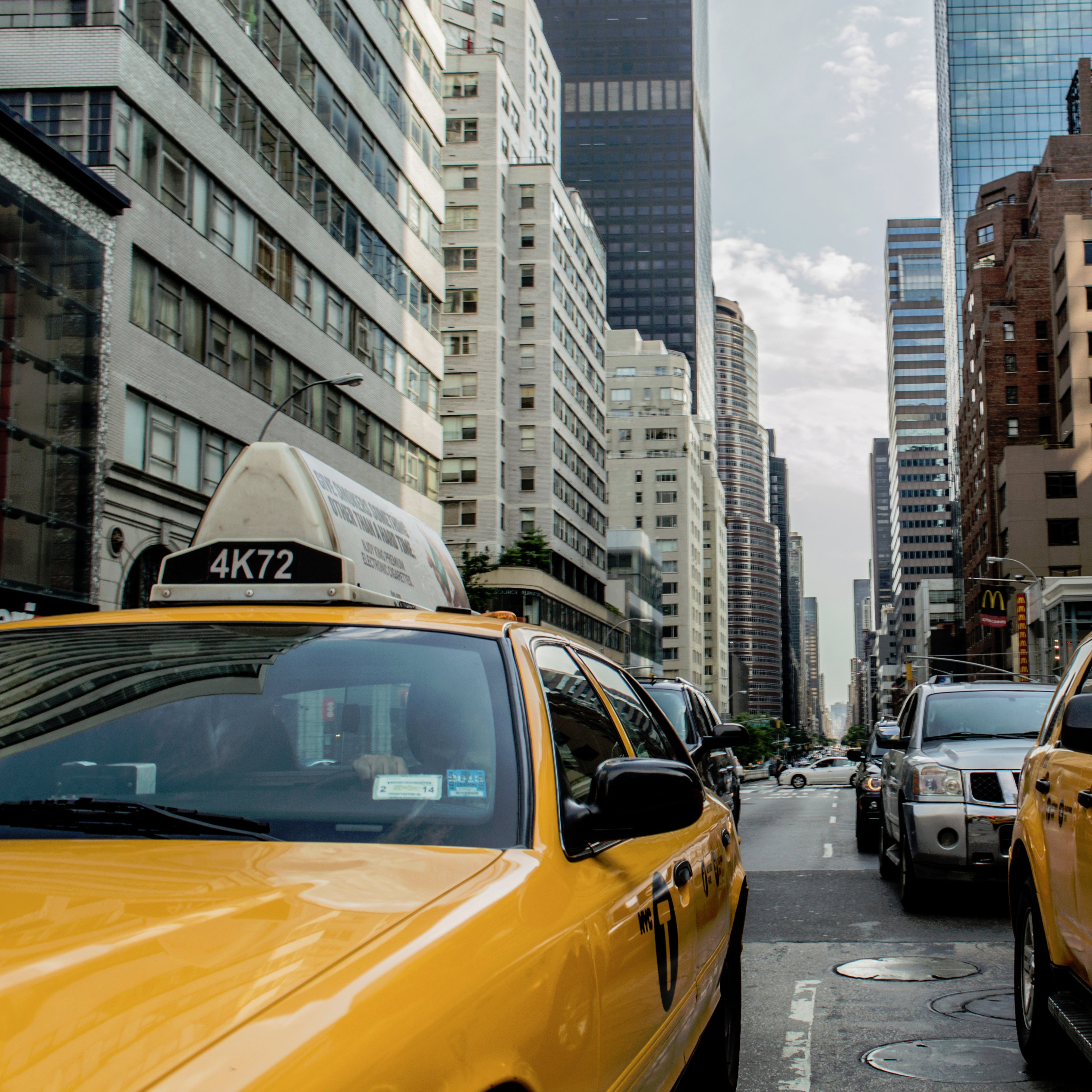 Yellow New York taxis with skyscrapers in the background