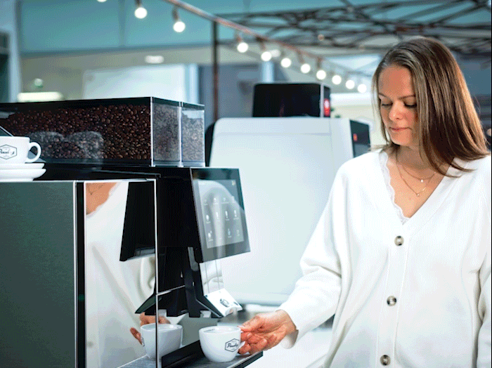 An employee having coffee from a coffee machine