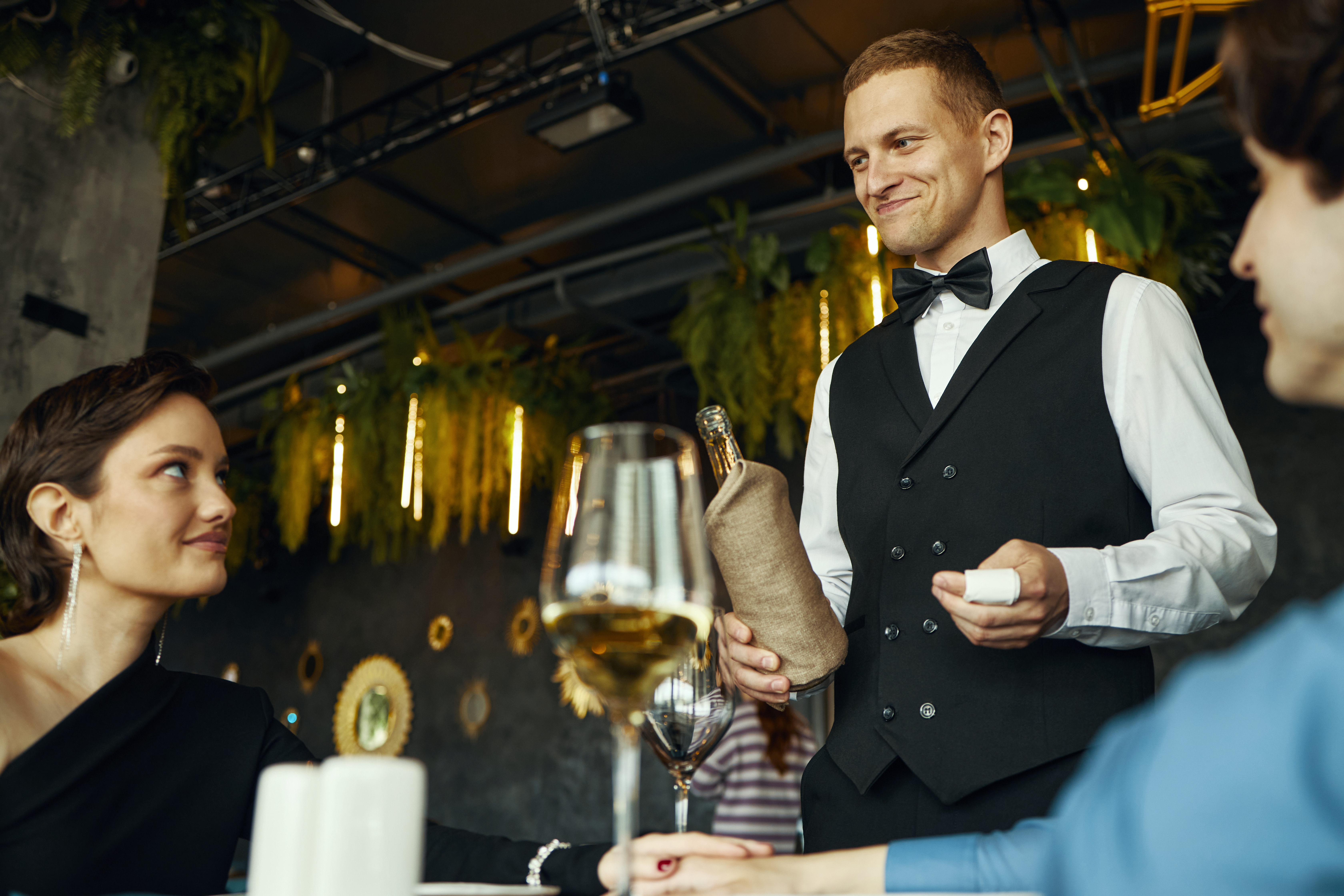 caucasian-young-adult-man-serving-wine-to-multieth-2025-09-09-17-36-16-utc