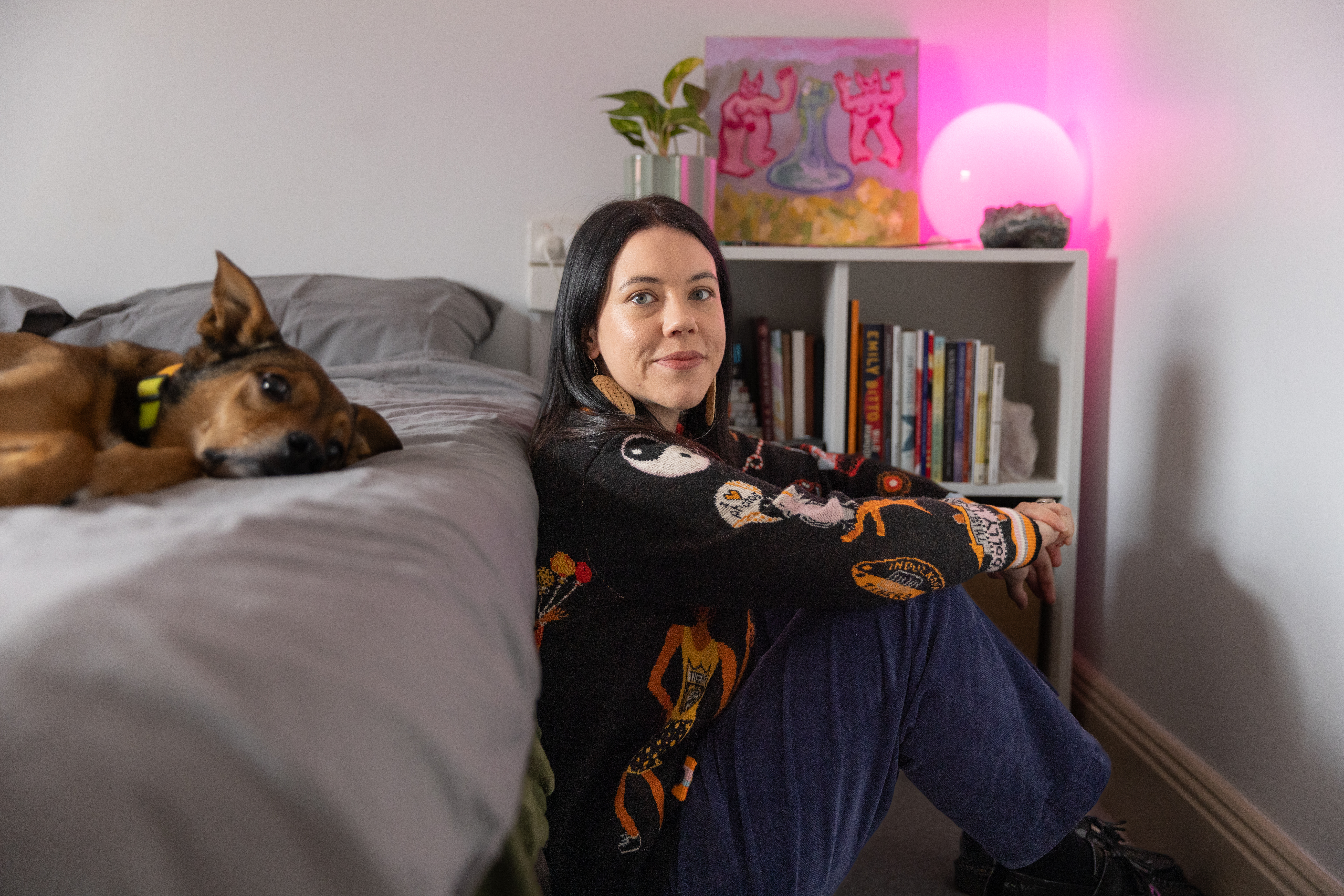 Lucy and their dog. Lucy wears WAH-WAH x Kaylene Whiskey wool jumper. This was a collaboration with Yankunytjatjara artist Kaylene Whiskey from the Iwantja Arts Centre in South Australia. Photo: Brendan Blacklock / City of Sydney 