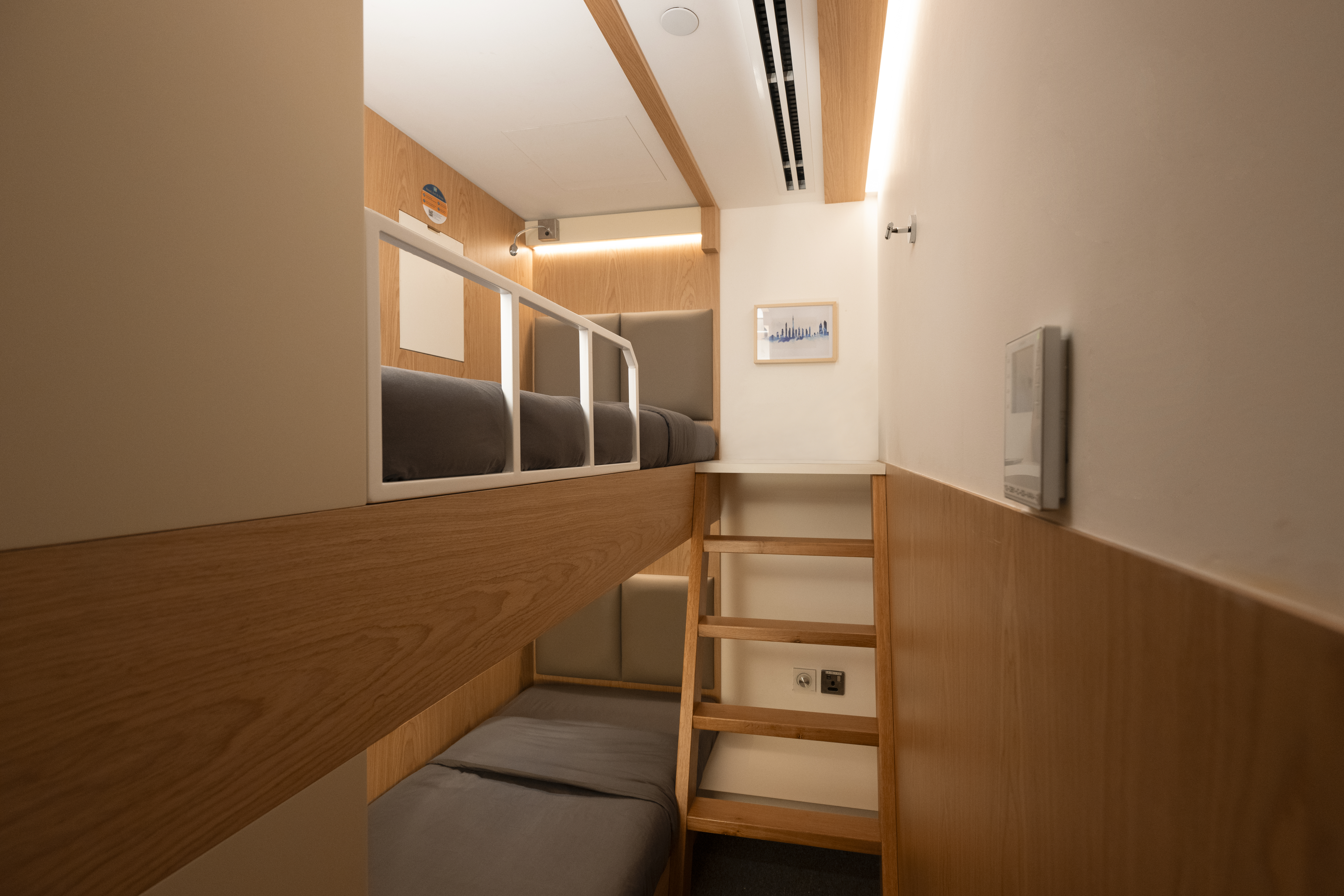 airport sleep lounge, bunk beds, grey bedding 