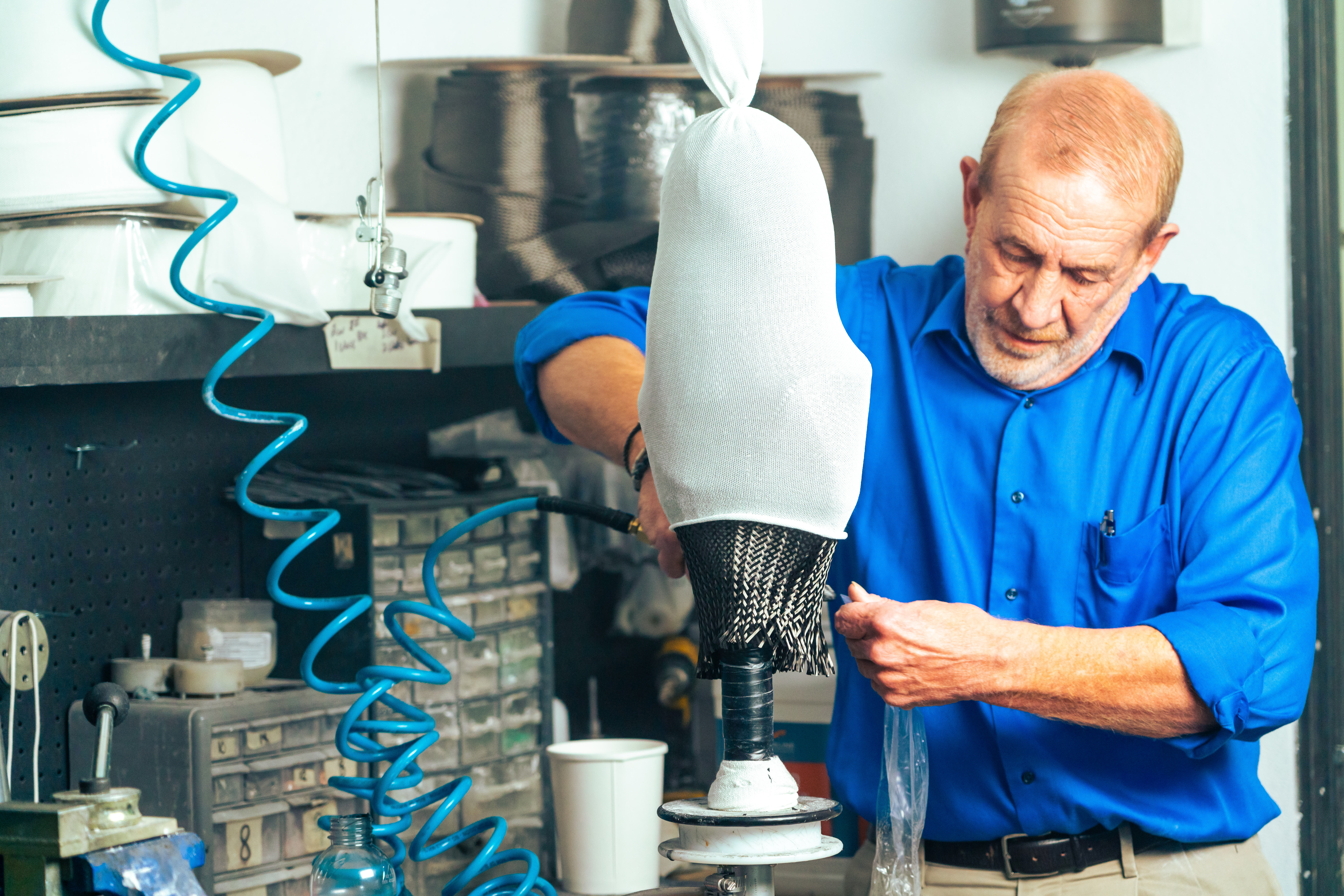 A orthotic and prosthetic technician creating a prosthetic socket in a lab