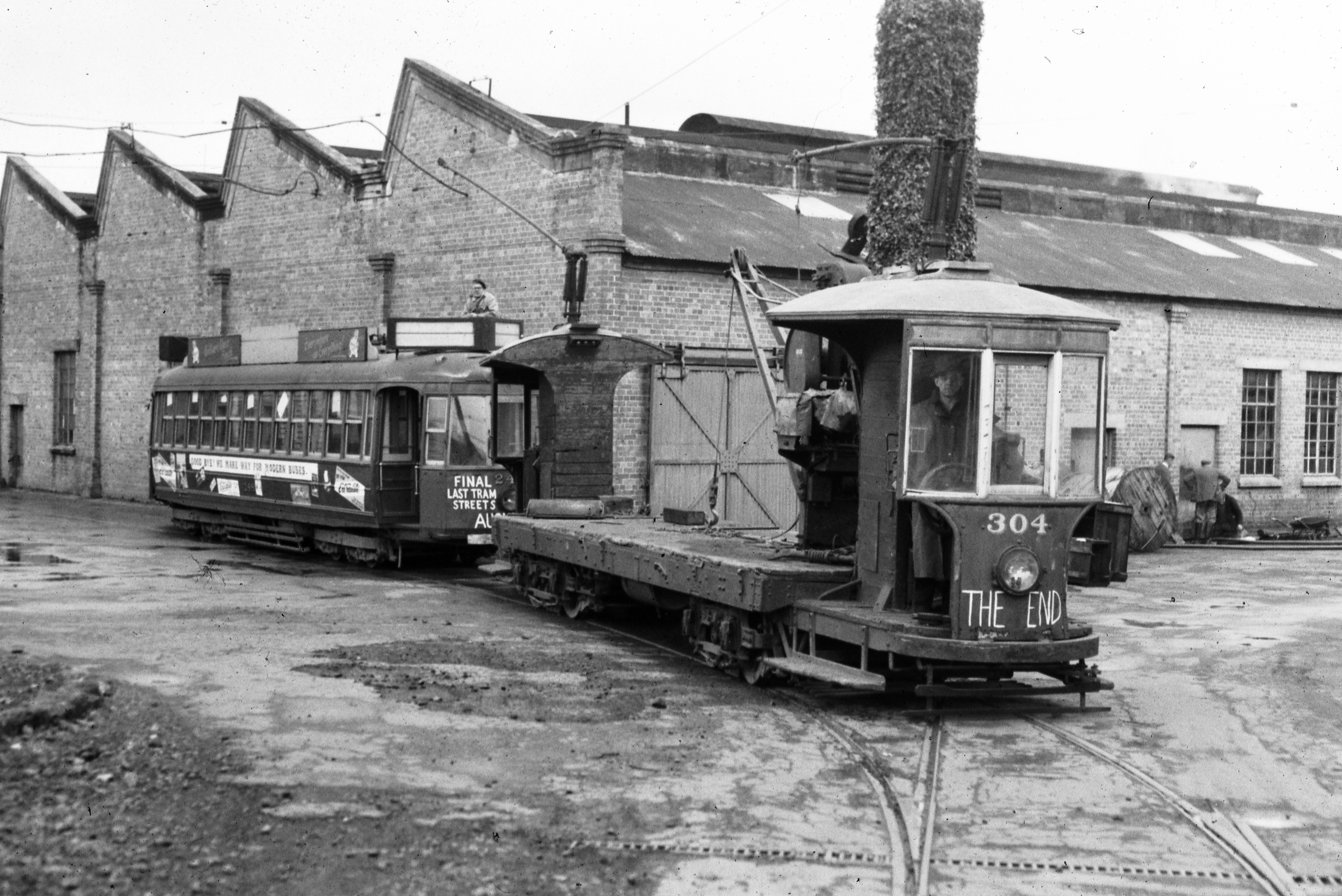 Graham Stewart. July 1957.  Freight and crane tram 304 towing 248 at the Manukau Road Workshops, ready for the journey to Matakohe, Te Tai Tokerau. No.304 becoming the last tram under power within the confines of the workshops on the original Auckland tram system. Supplied by David Cawood.  