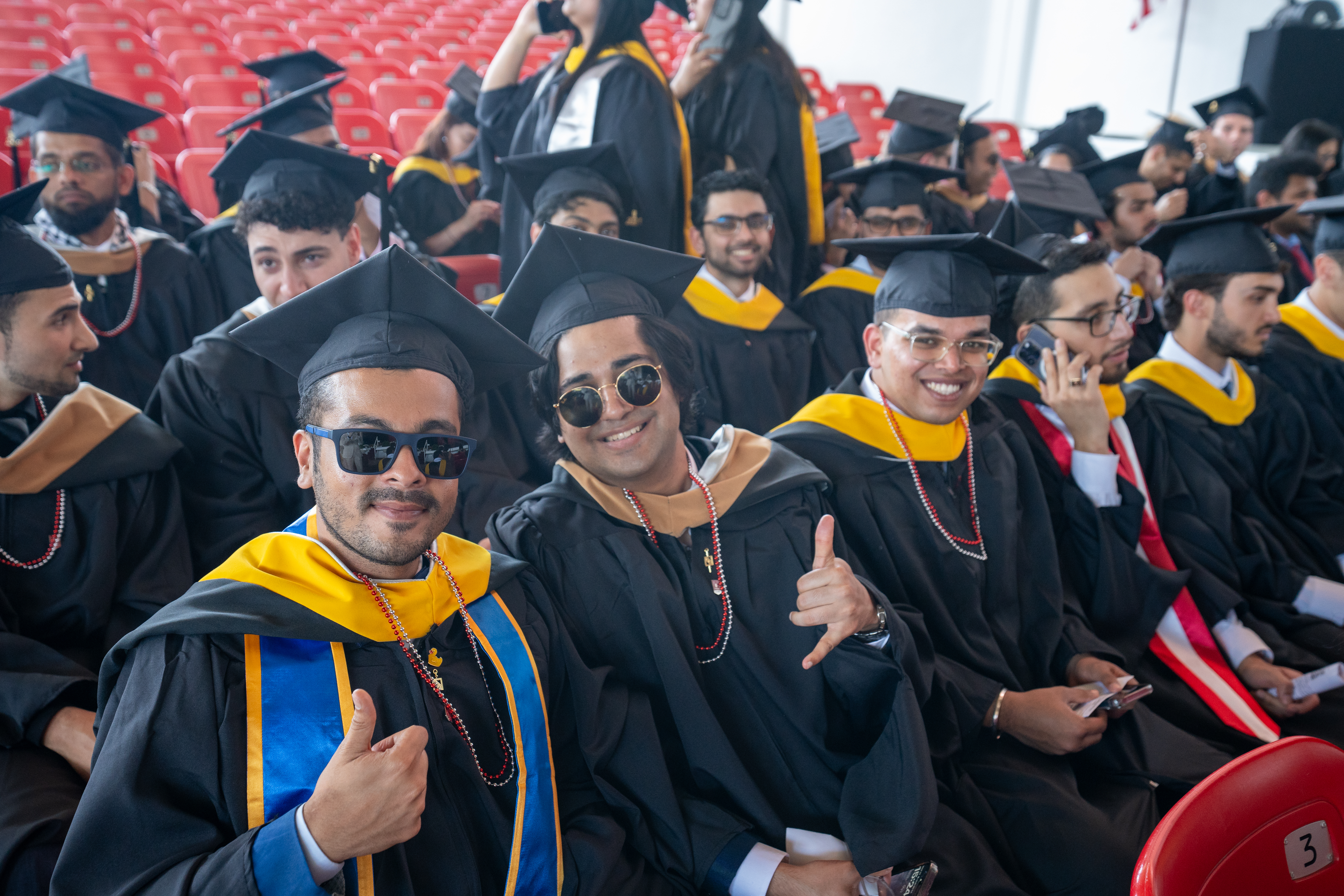 Group of graduate students smile and pose for camera
