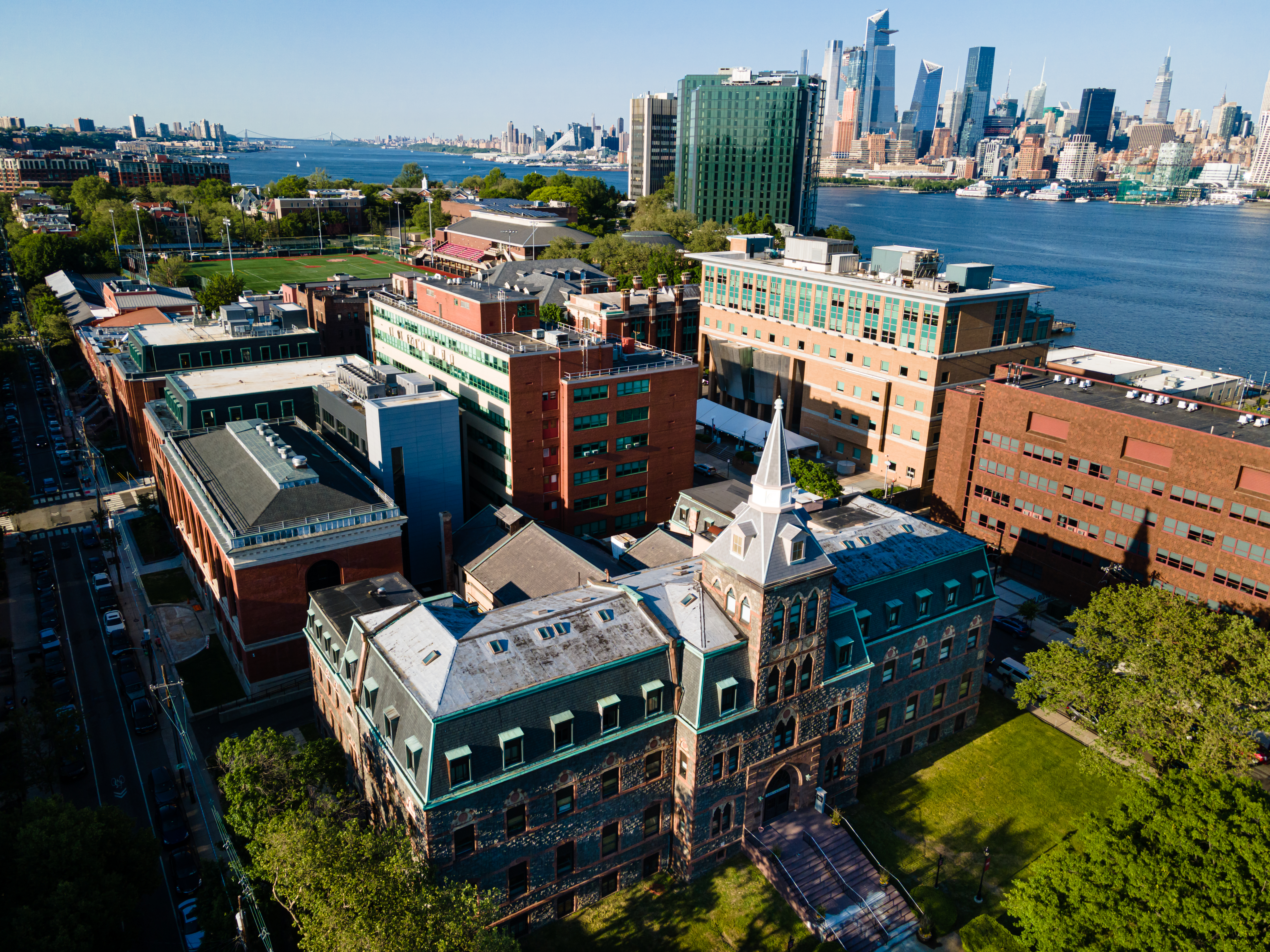 An aerial image of the Stevens campus across the Hudson River from Manhattan.
