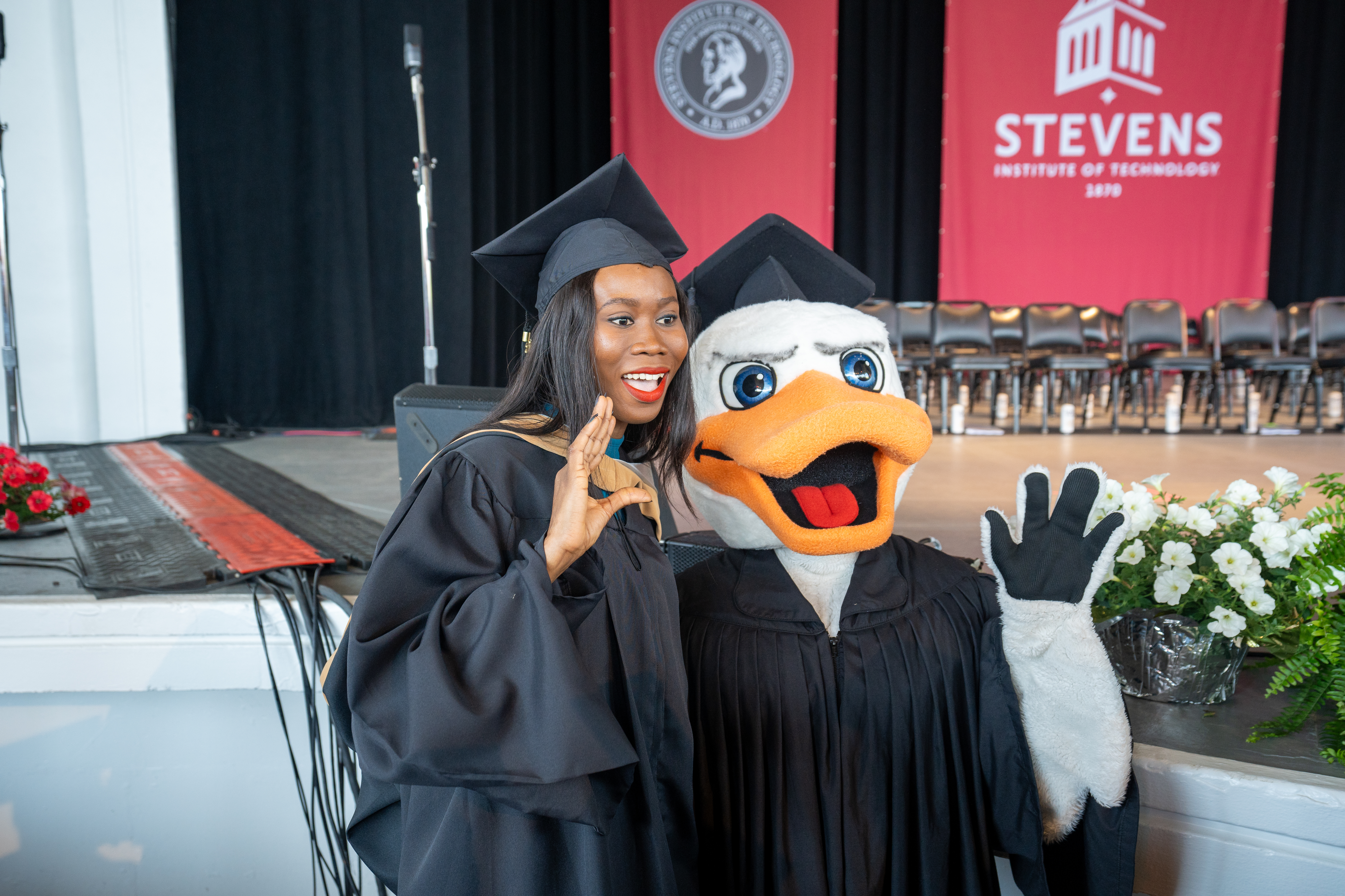 Attila poses with a student 