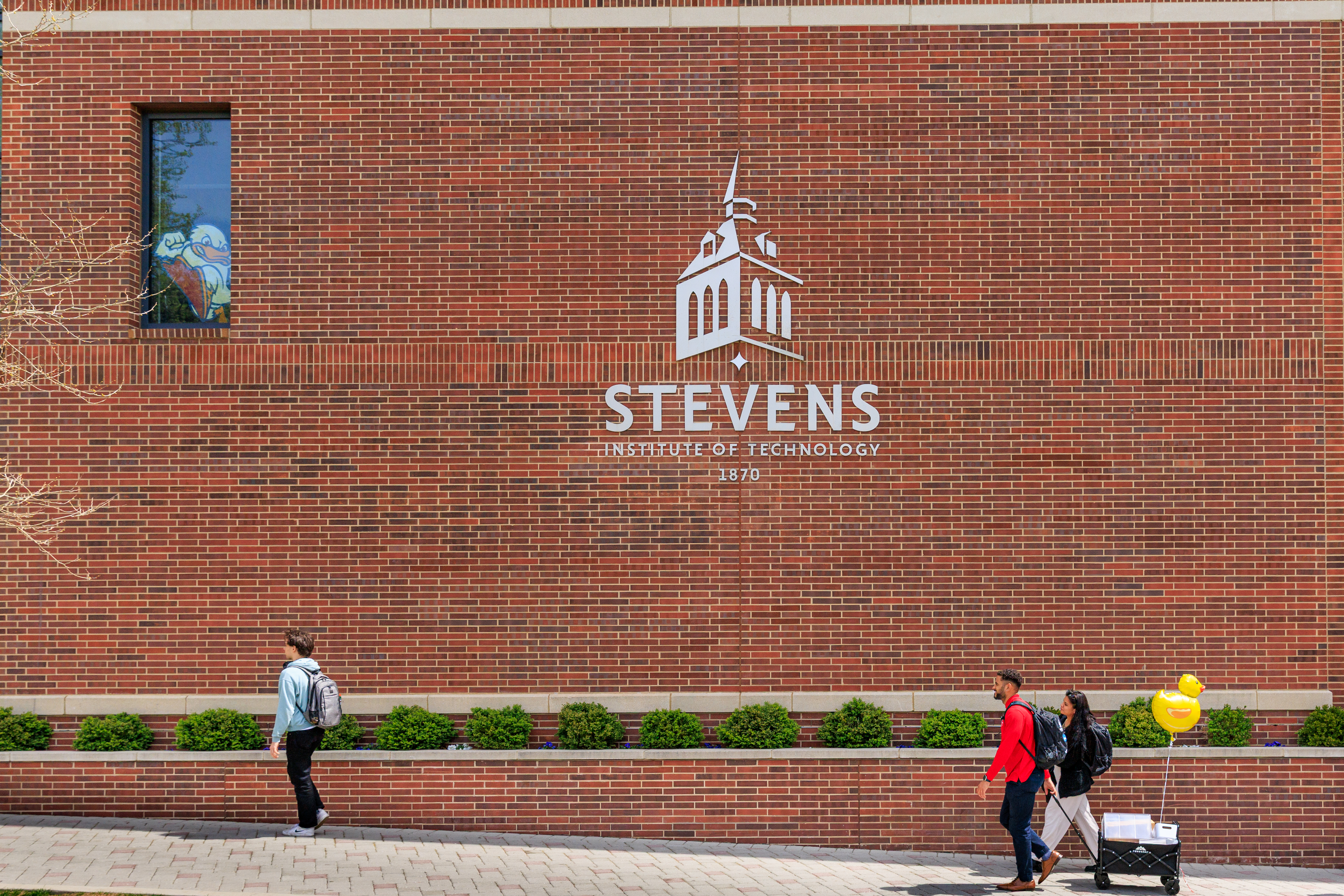 A brick wall with the Stevens logo on it.