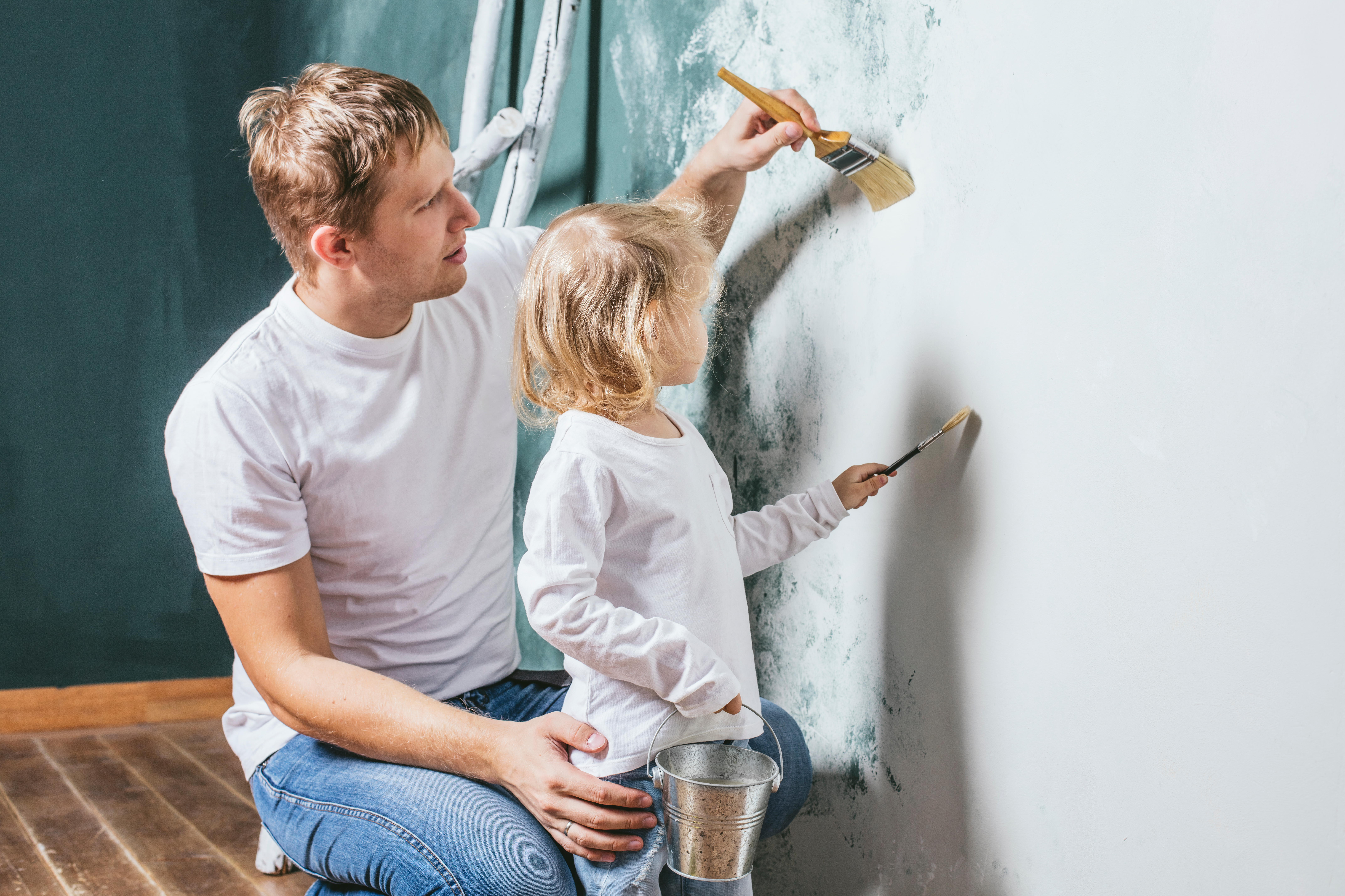 Dad and daughter paint house
