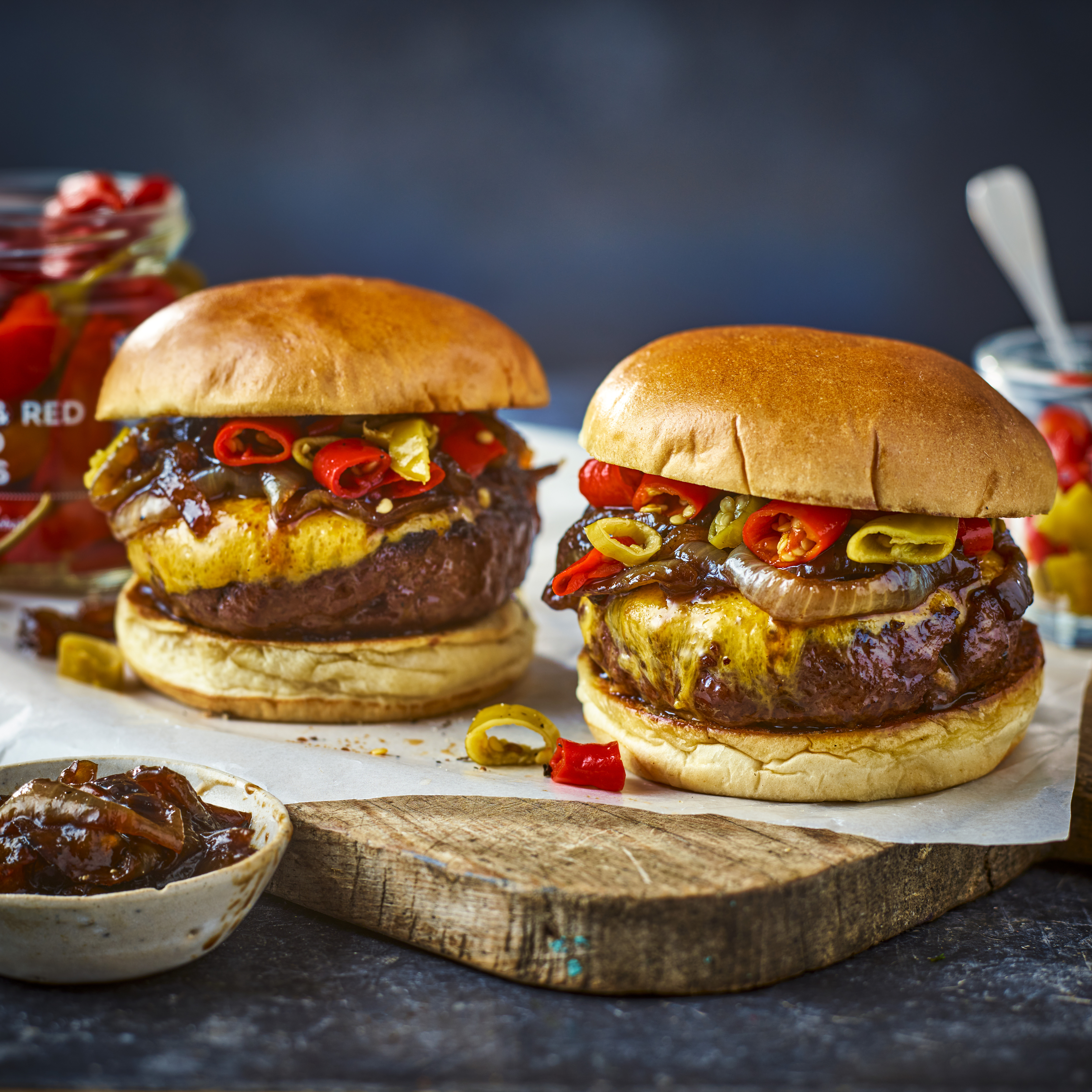 Two cheeseburgers and jar of picked chillies