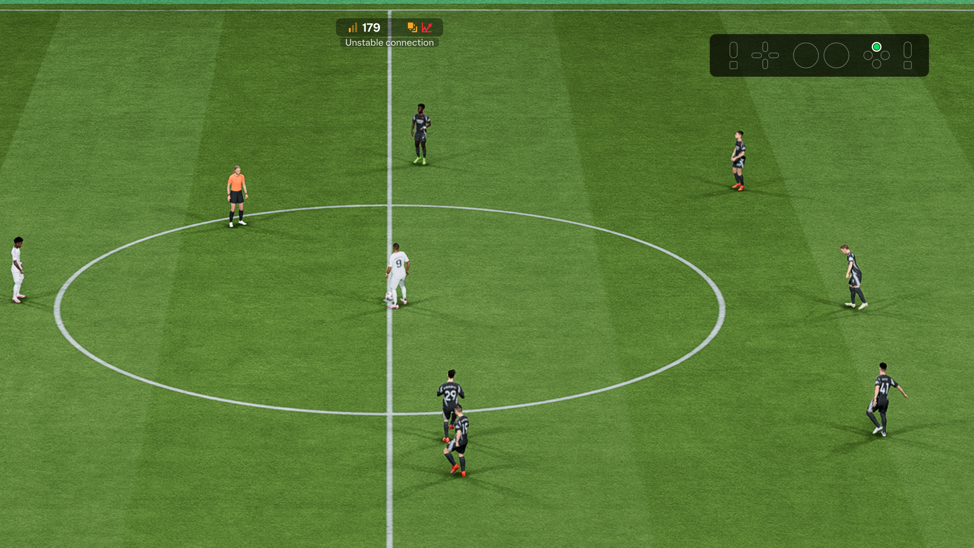 Soccer scene showing a kickoff between two teams, one in white and one in dark jerseys. Players are positioned around the center circle.
