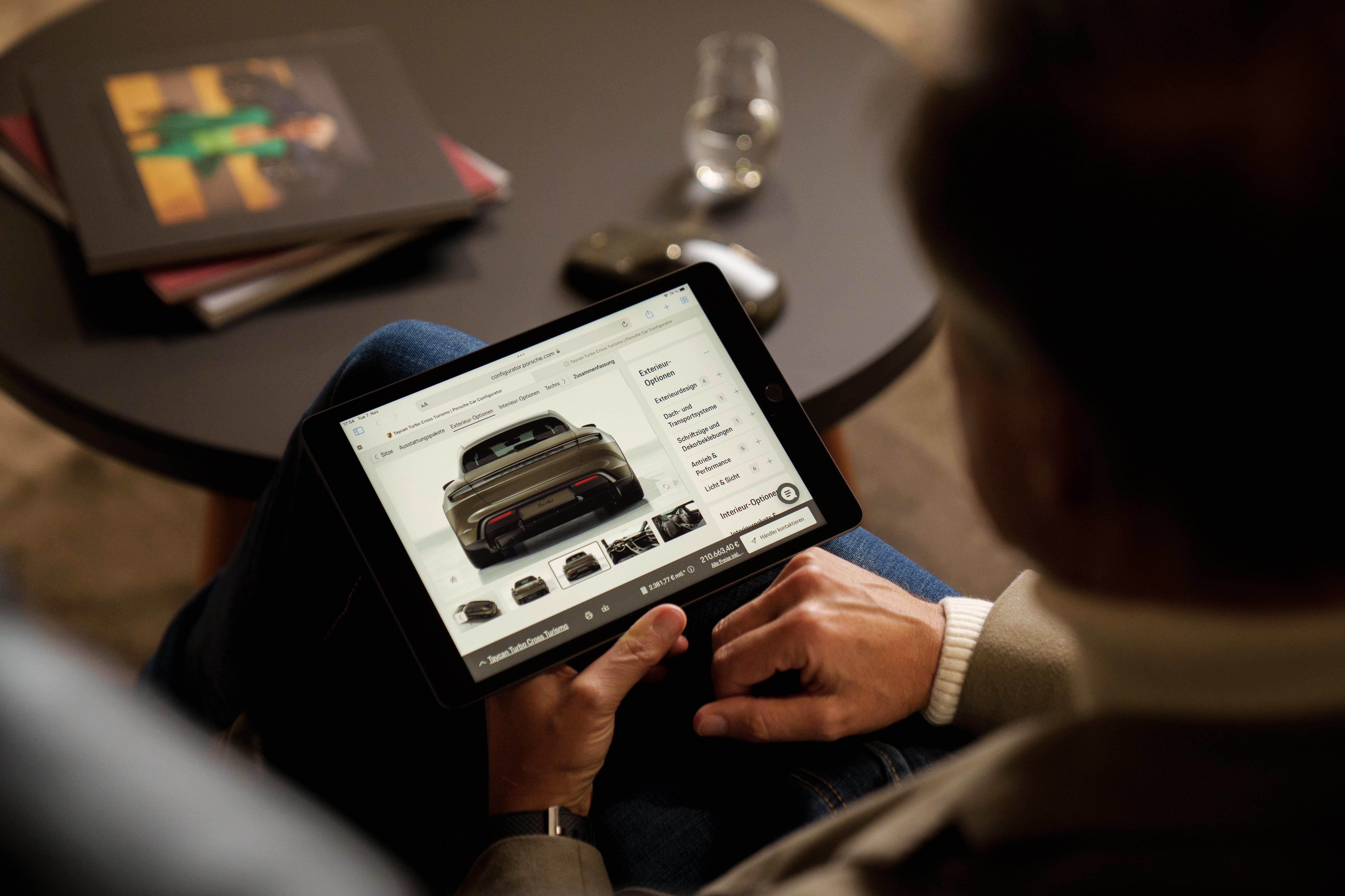 Man looks at iPad showing Porsche Car Configurator