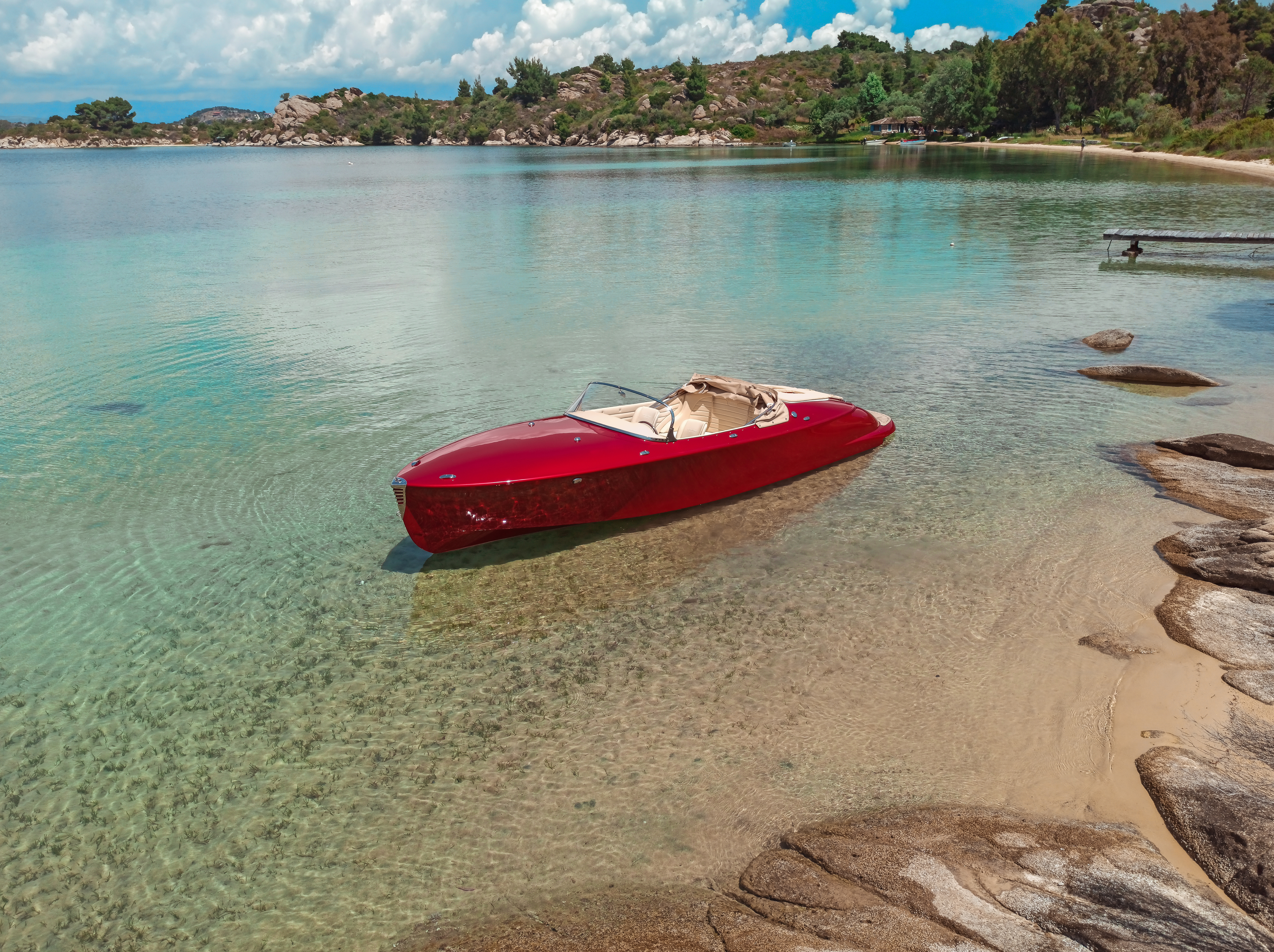Red Hermes Speedster moored in clear waters of an inlet