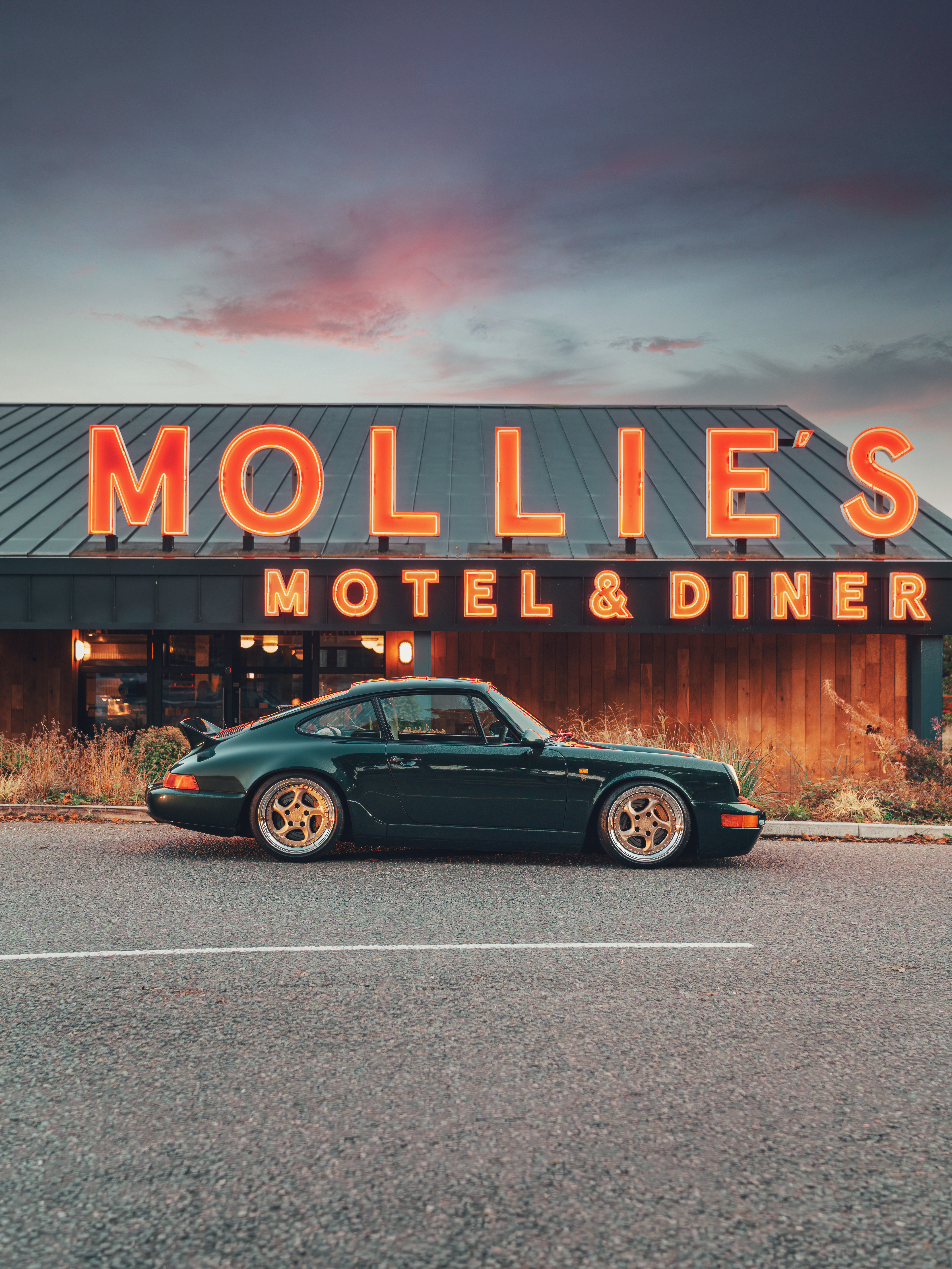 Porsche 911 (964) parked outside a diner with neon sign