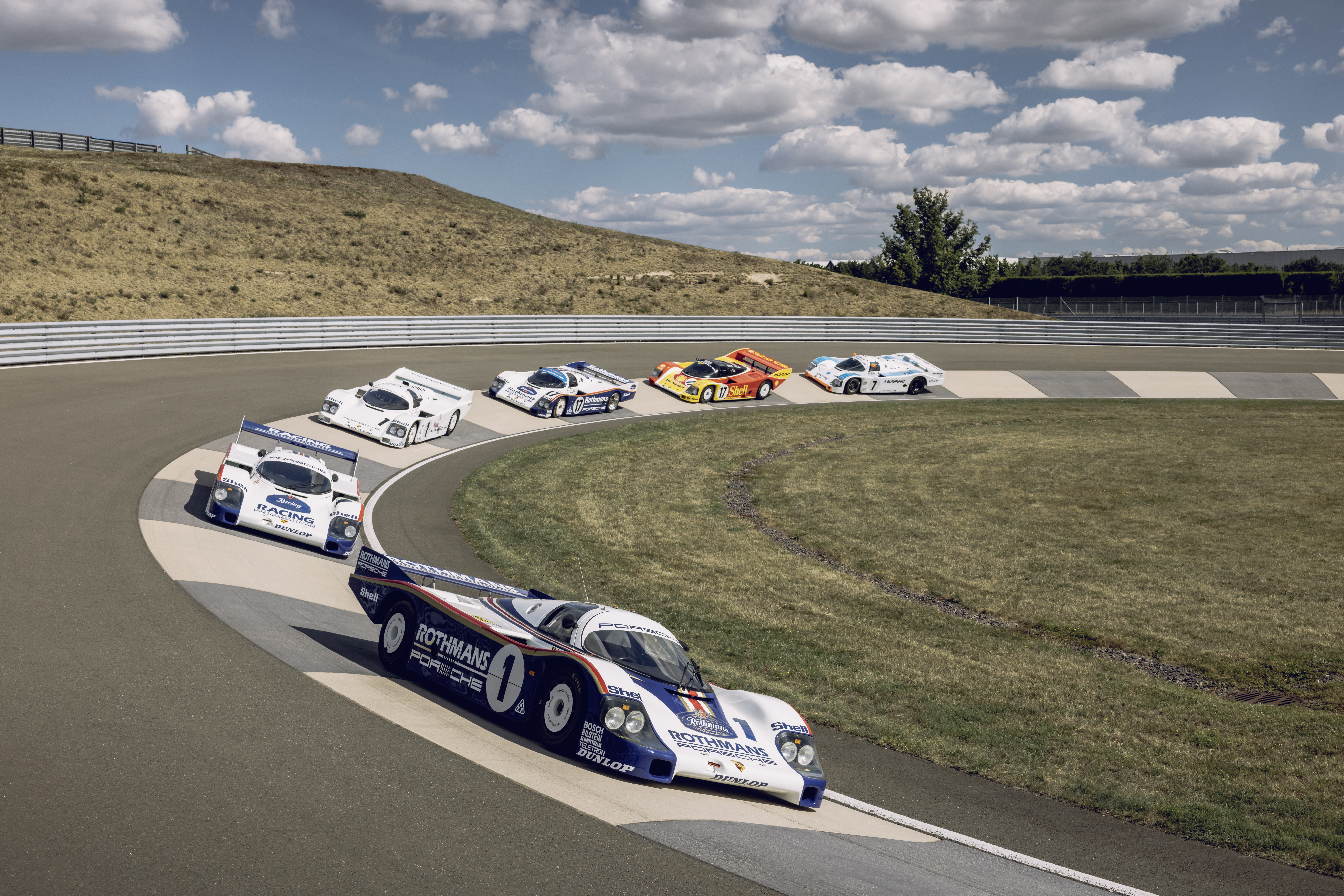 Group C Porsche cars cornering at a racetrack