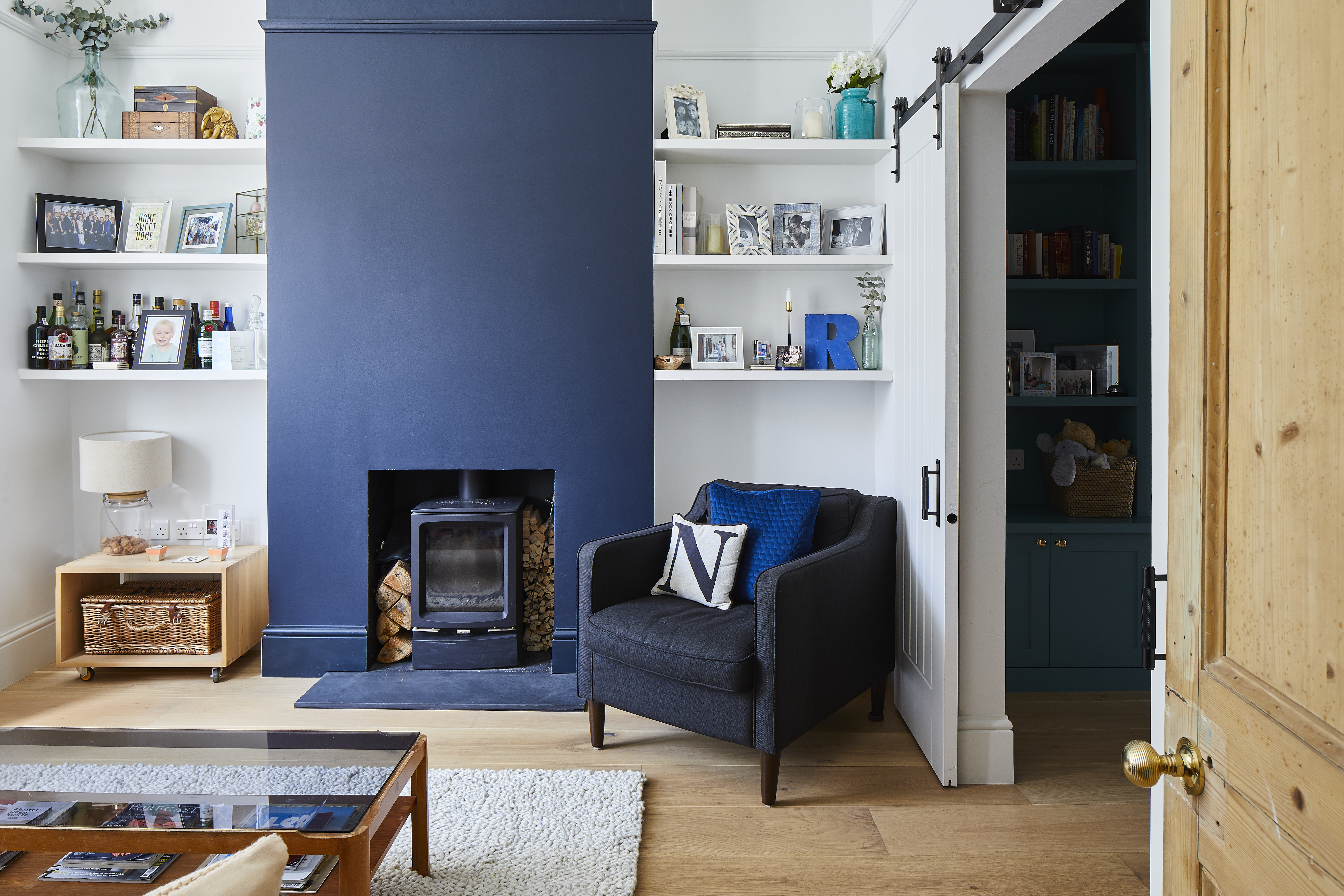 Living room with deep blue fireplace as centre point.