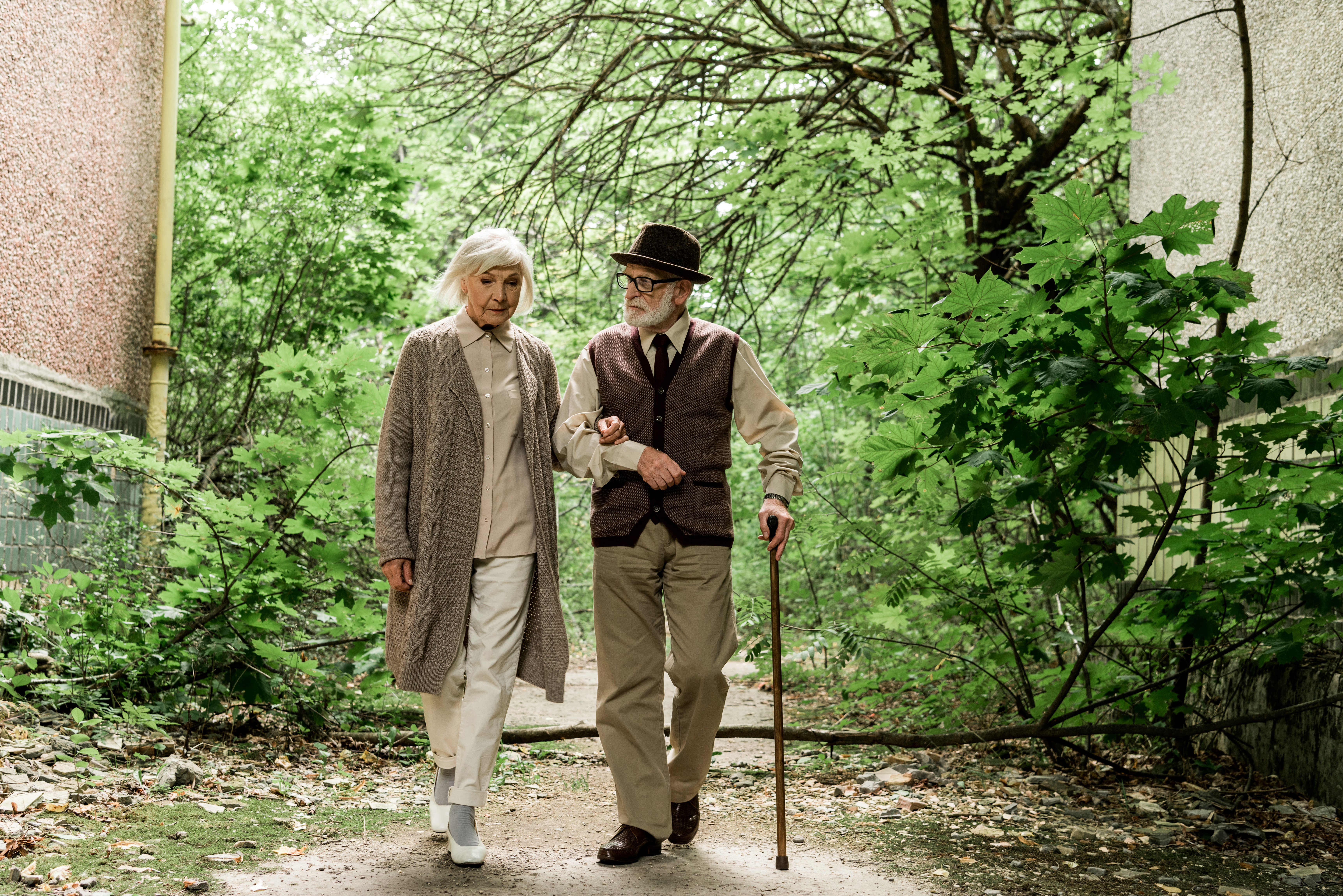 retired-woman-and-senior-man-with-walking-cane-wal-2023-11-27-05-31-41-utc.jpg