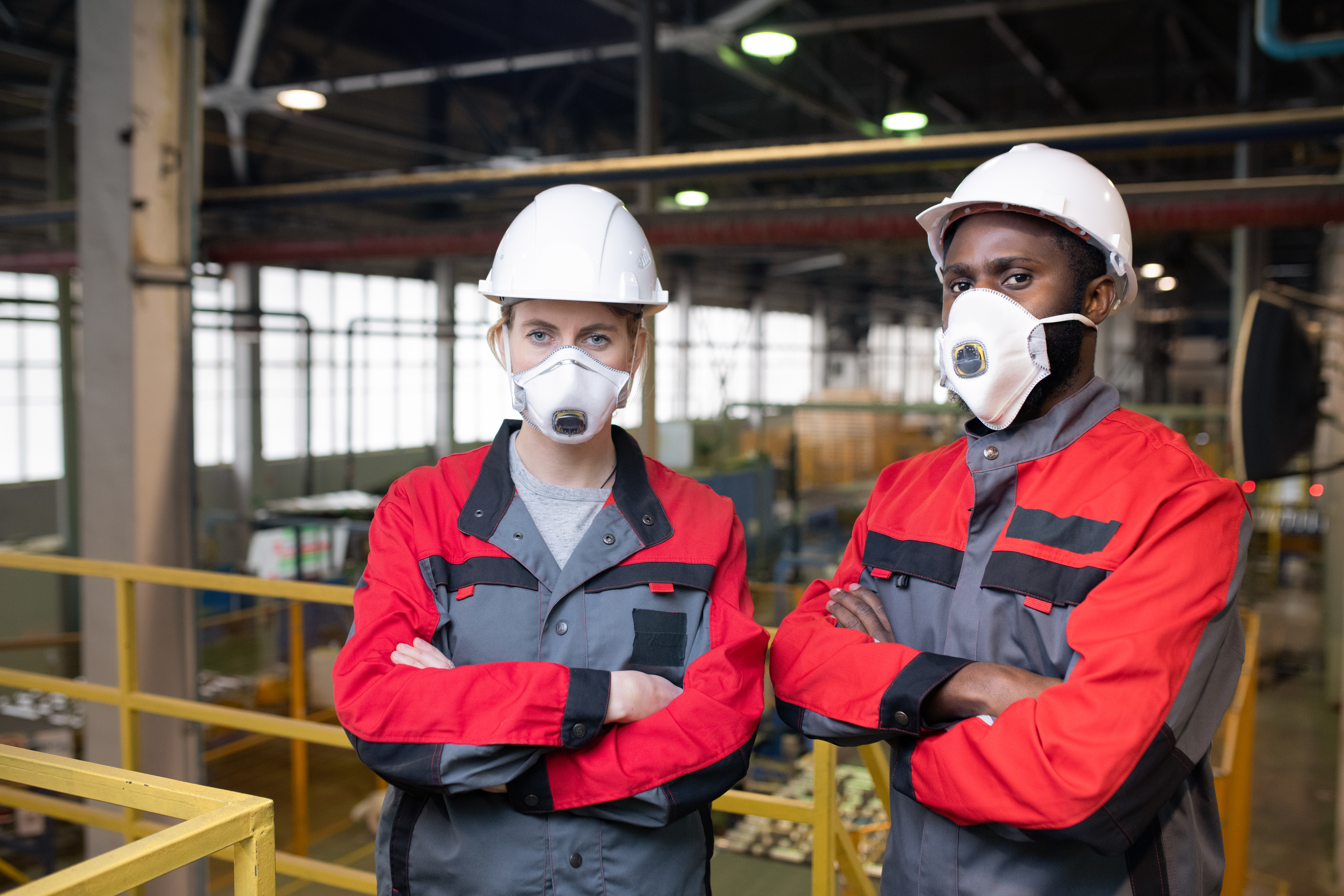 Workers wearing respiratory masks in a factory
